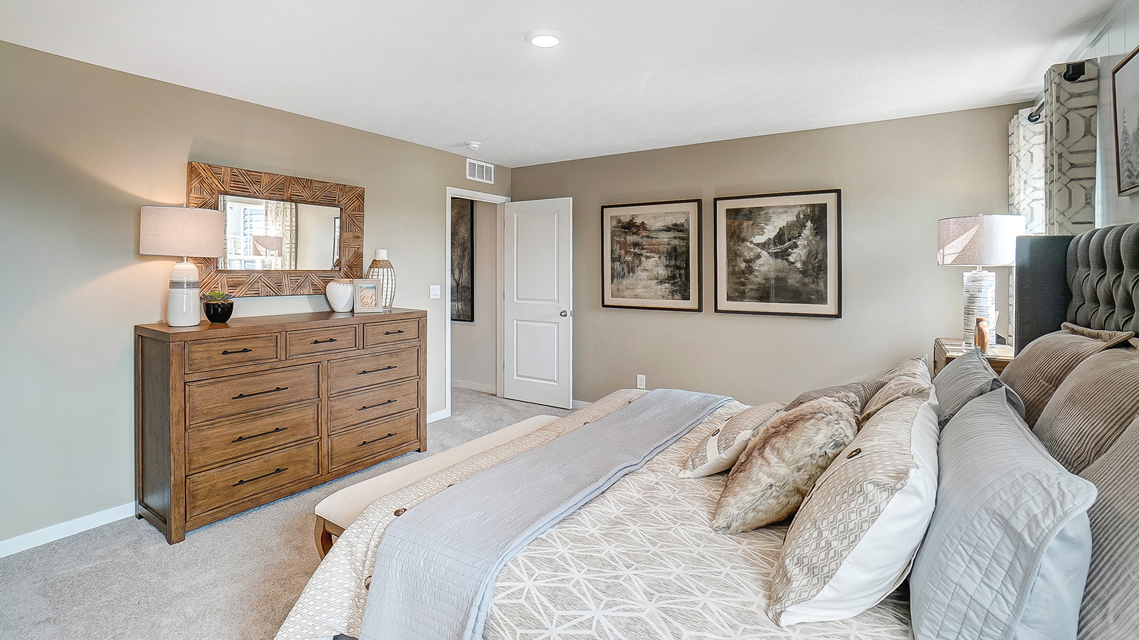 Primary bedroom with wooden décor with large king bed.