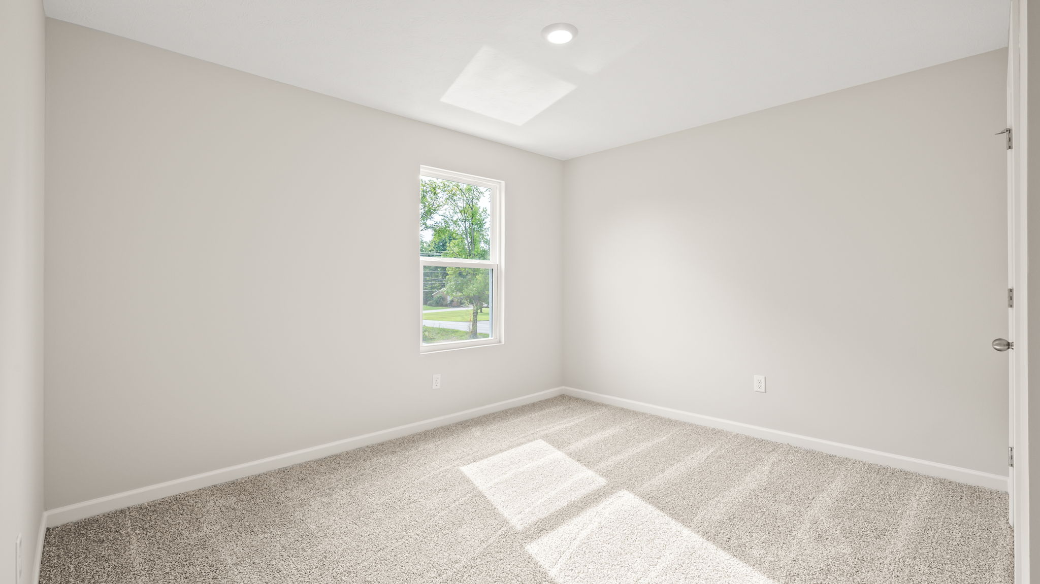 Carpeted bedroom with window