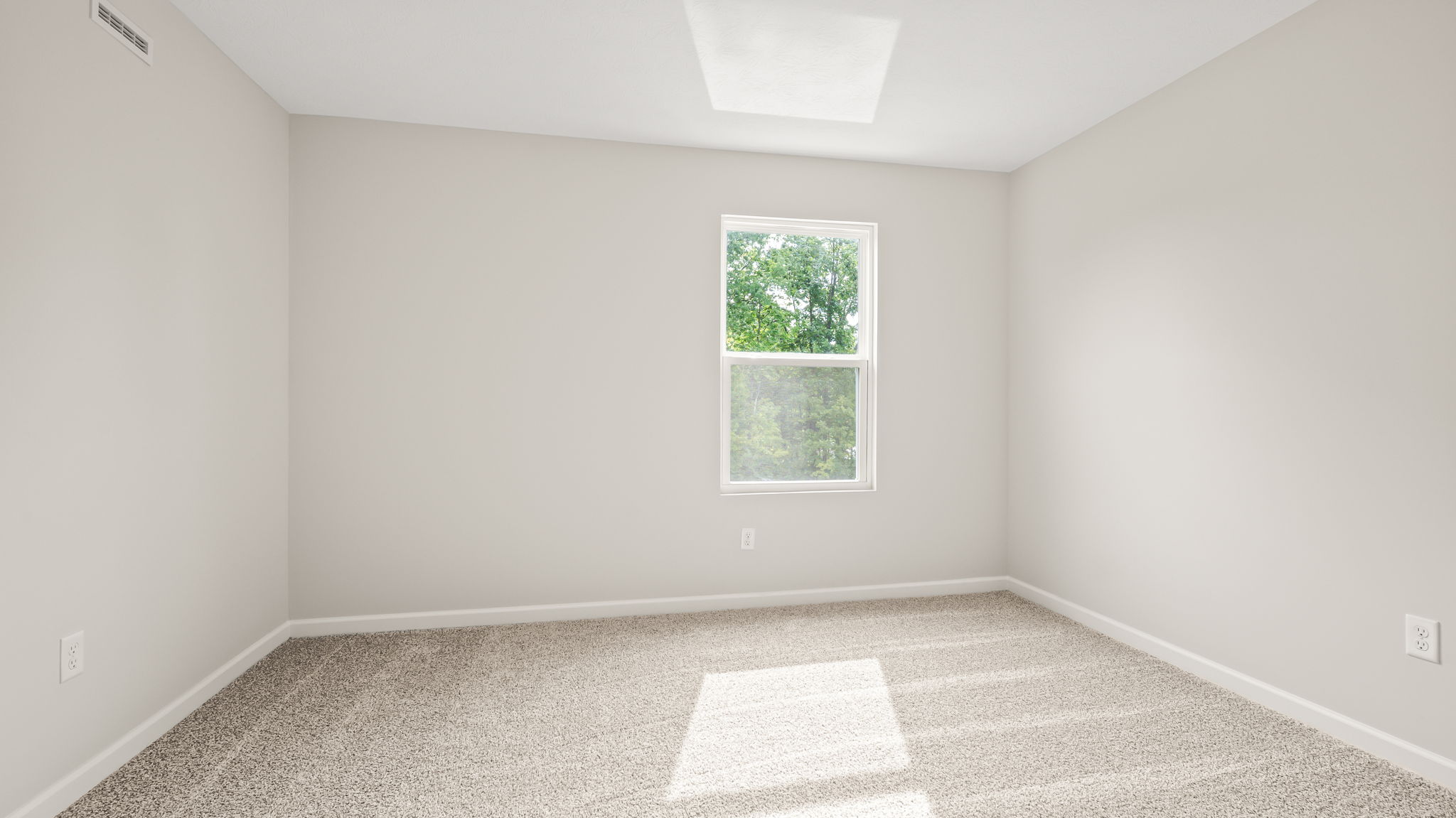 Carpeted bedroom with window
