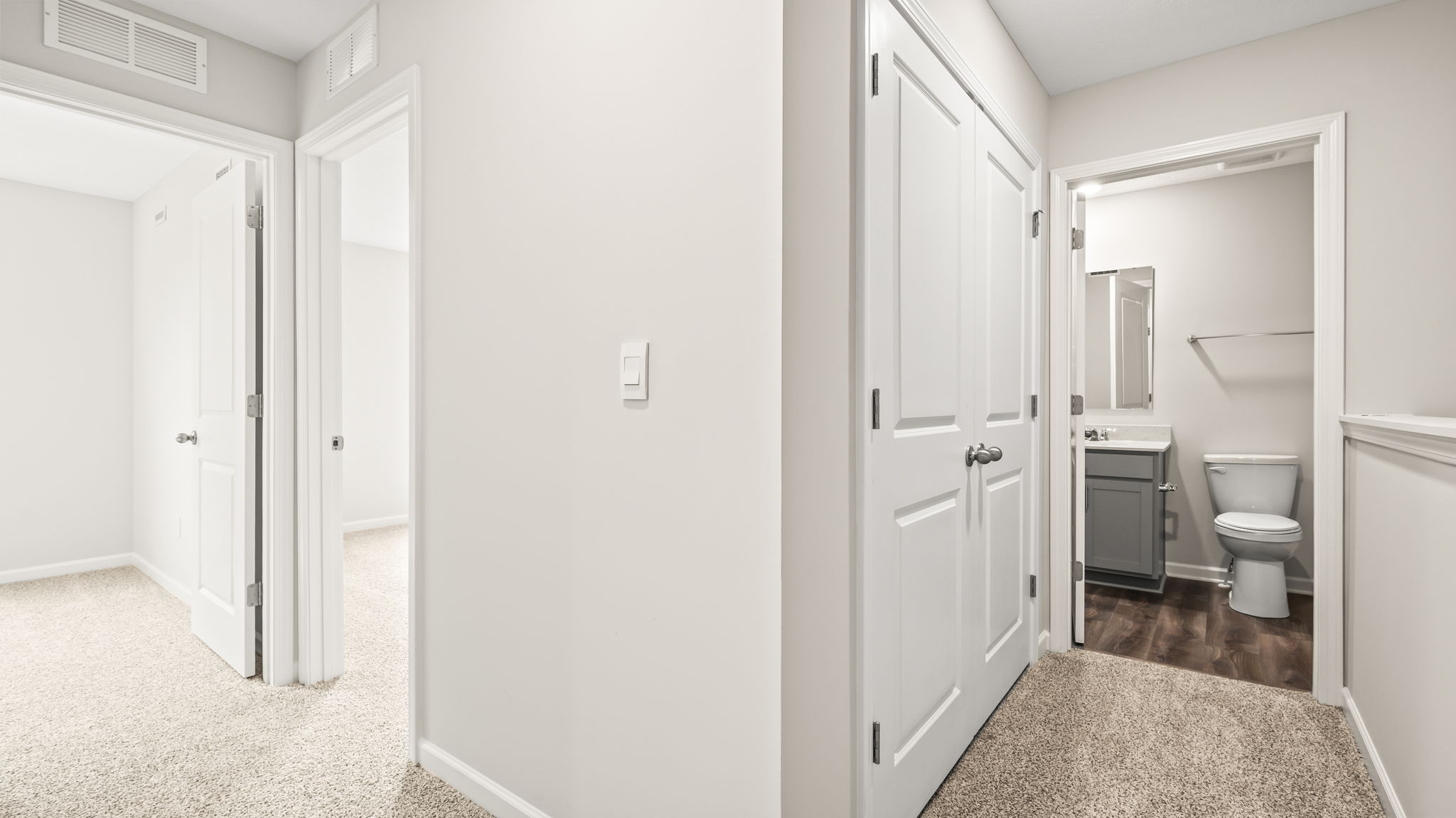 Upstairs hallway with view of bedroom and bathroom