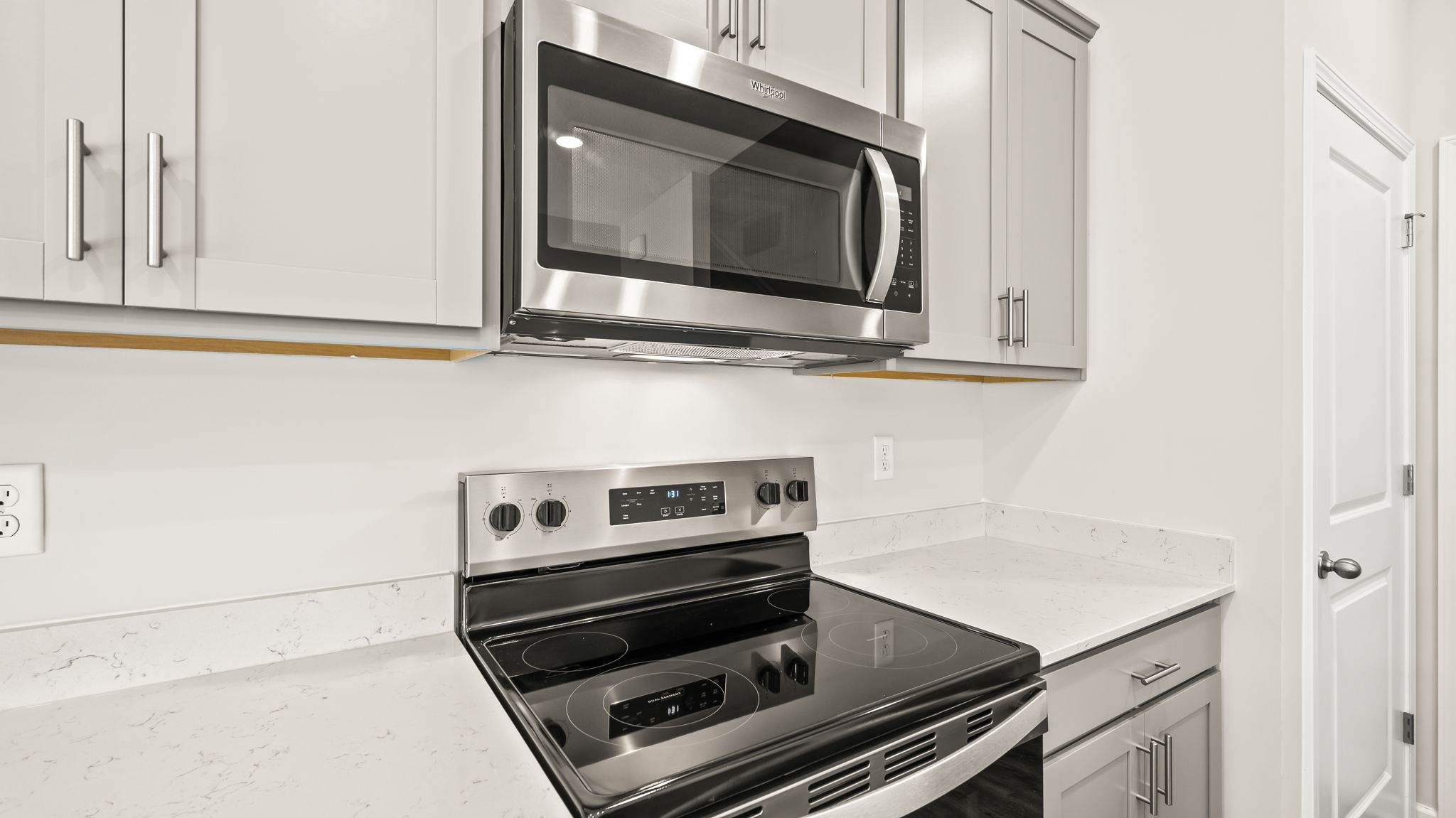 Closeup of oven range with microwave above