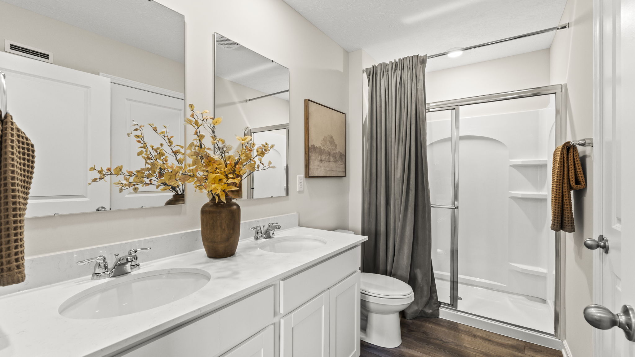 Primary Bathroom with sinks, shower, and modern decoration