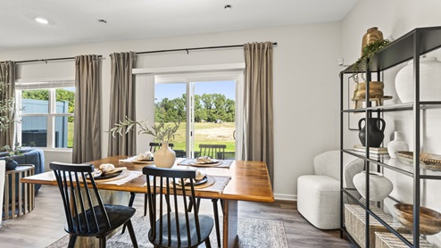Dining area with shelving, pottery decoration, and table dressing