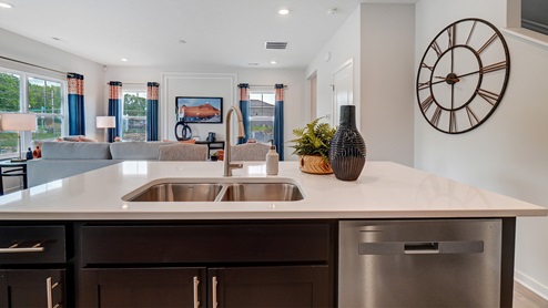 Kitchen sink with stainless steel appliances and dual sink.