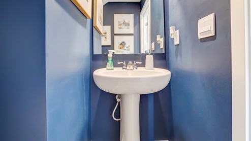 Powder room on the first floor with modern art.