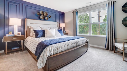 Primary bedroom with wooden décor with large king bed.