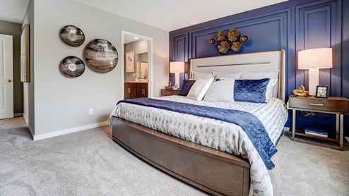 Primary bedroom with wooden décor with large king bed.
