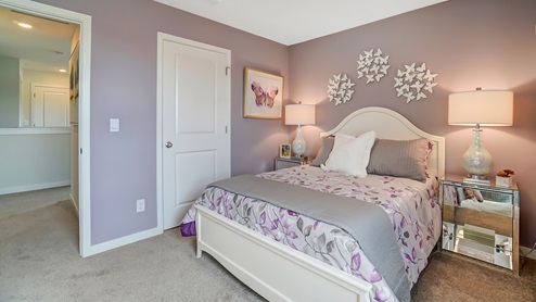 Bedroom with white décor and butterfly decorations.