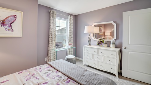Bedroom with white décor and butterfly decorations.