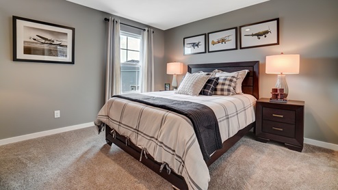Bedroom with wooden décor and plane style theme.