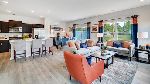 Great room in full with moder decorations and white cabinets.