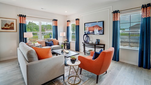 Great room in full with moder decorations and dark cabinets.