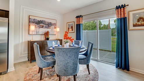 Dining area with wooden table and modern decorations.