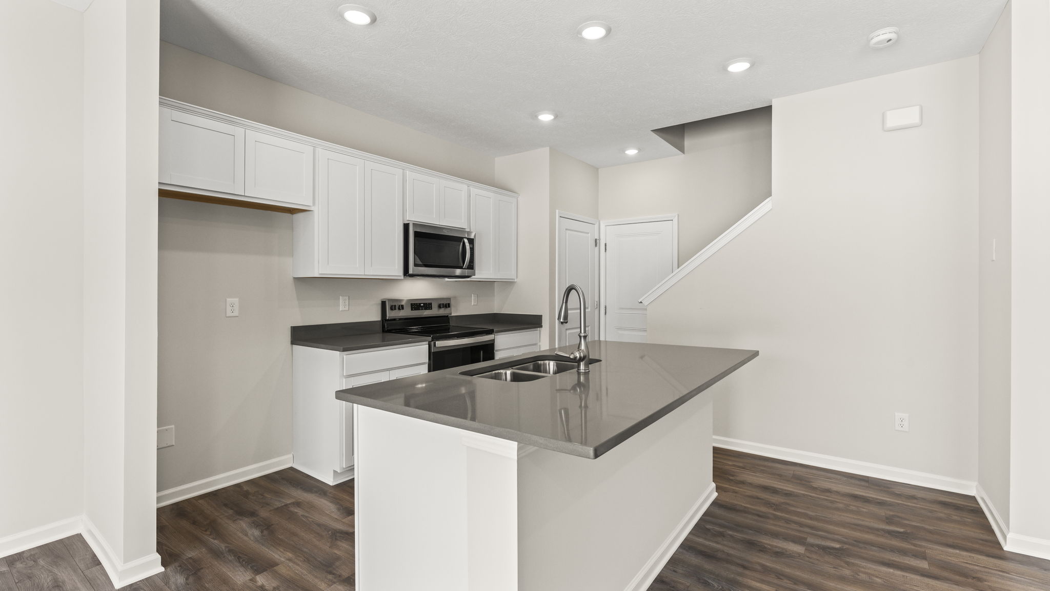 Kitchen with quartz countertops, elkins crown cabinetry, and appliances.