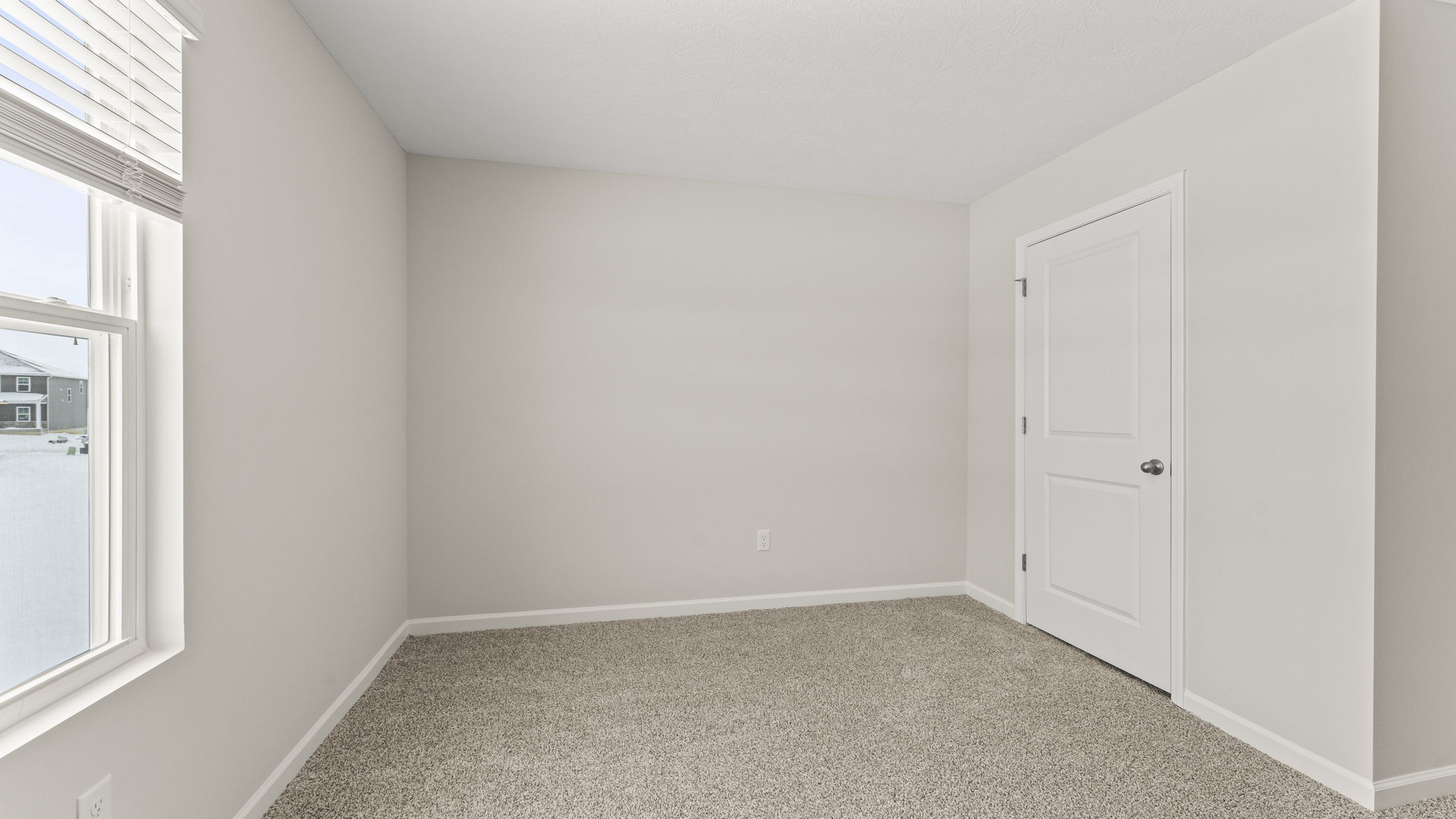 Carpeted bedroom with closet door in frame