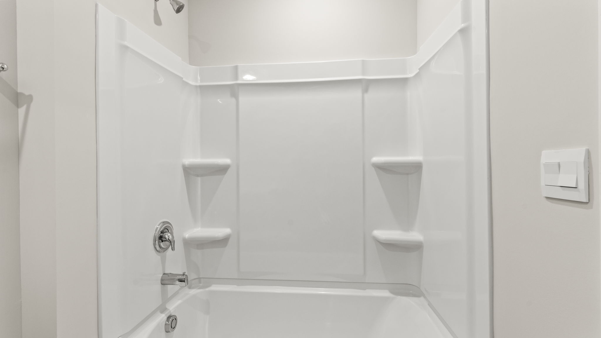 Closeup of tub with tiered shelving