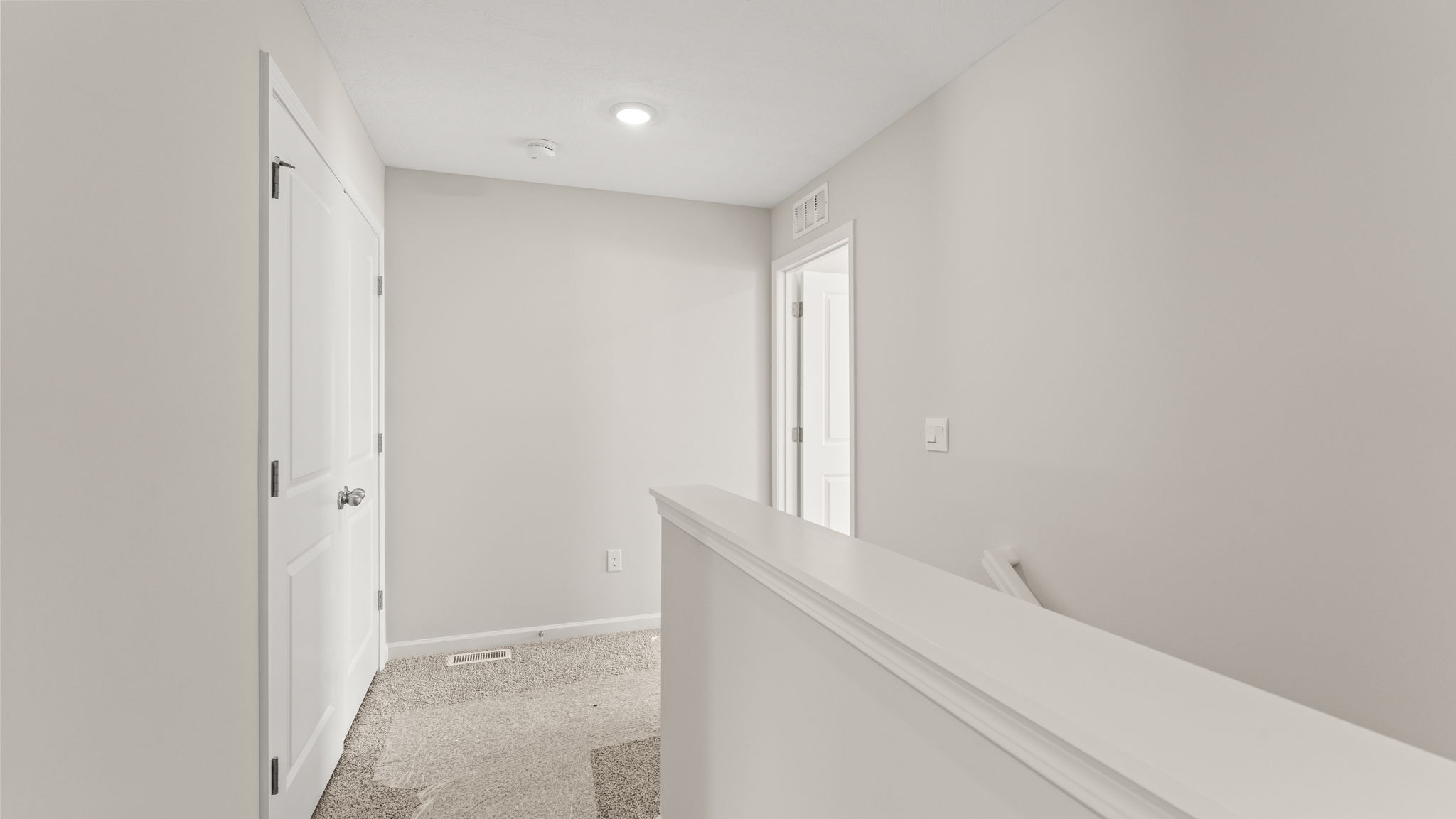Upstairs hallway leading to stairs