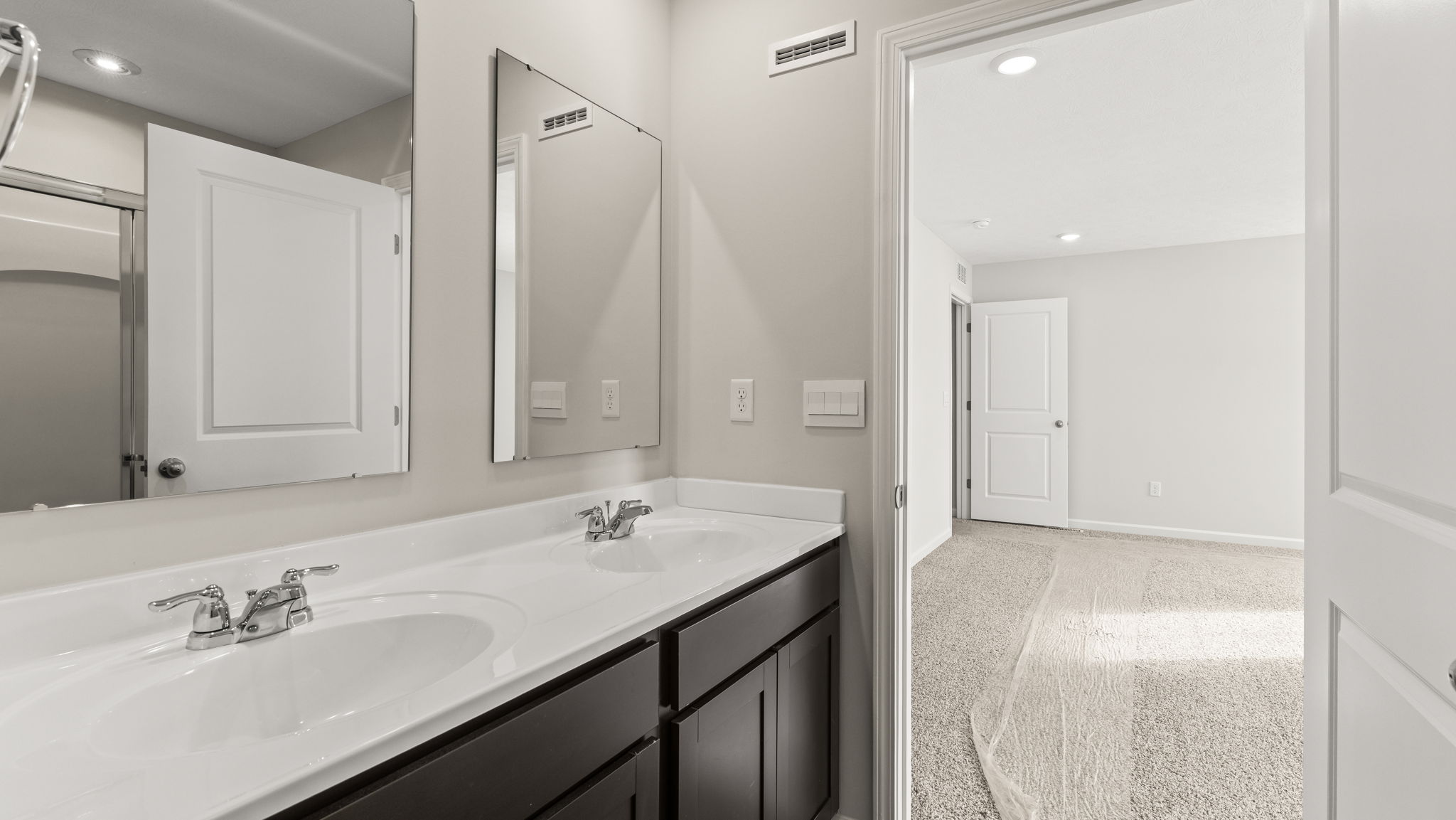 Primary bathroom with dual-sink and mirror