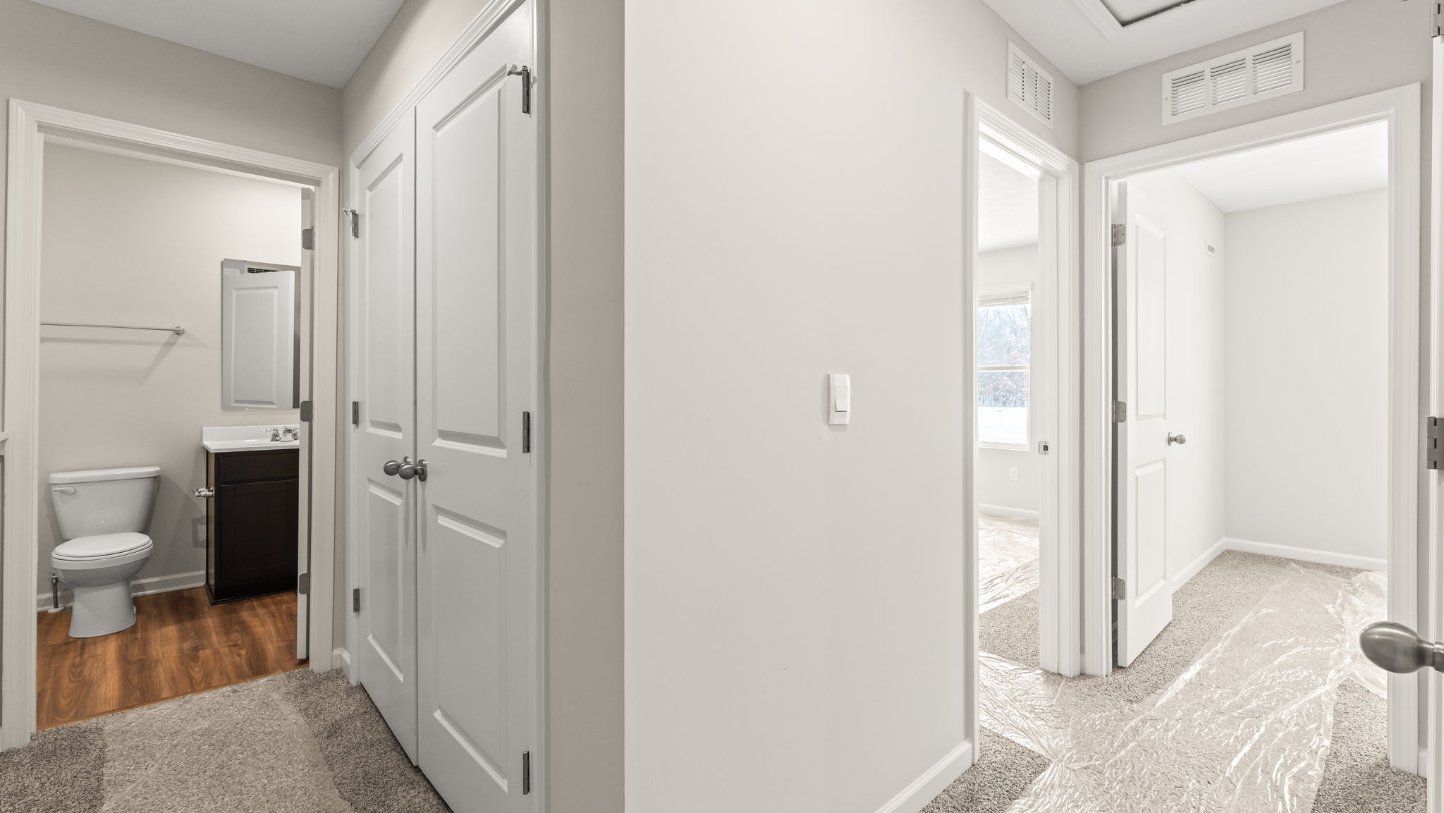Upstairs hallway with view of bedrooms and bathroom