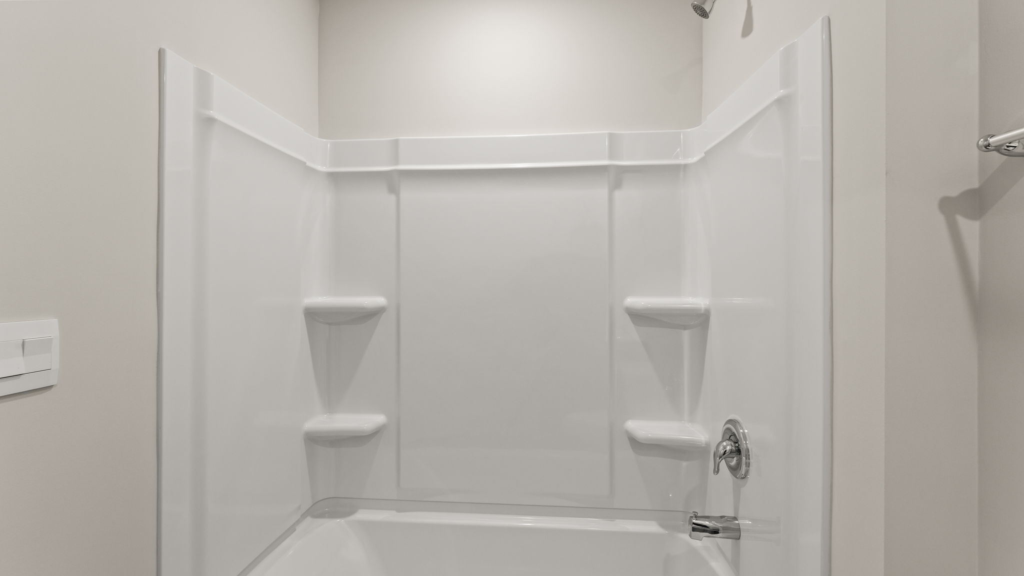 Closeup of tub with tiered shelving.