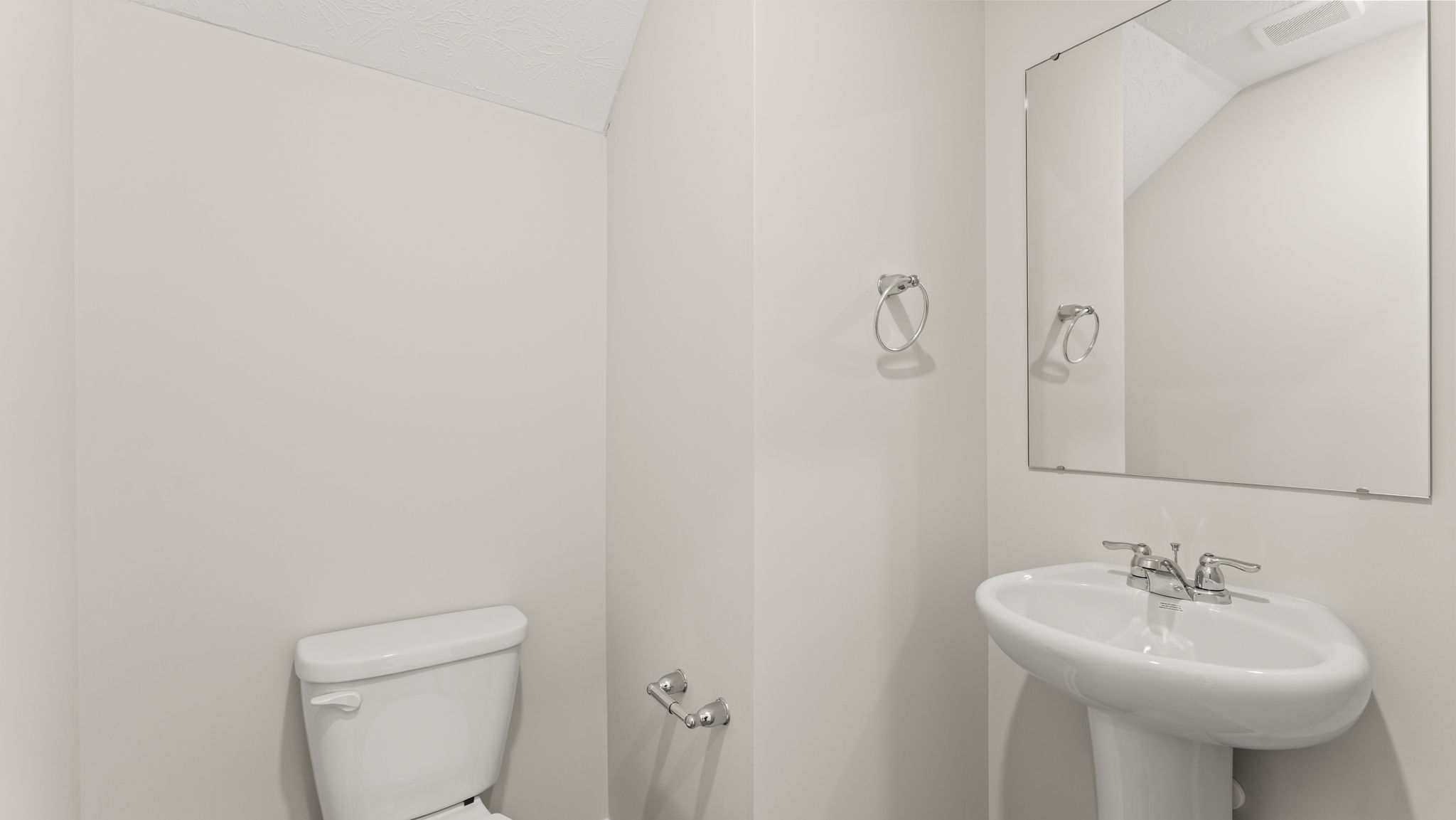 Downstairs powder room with sink and mirror