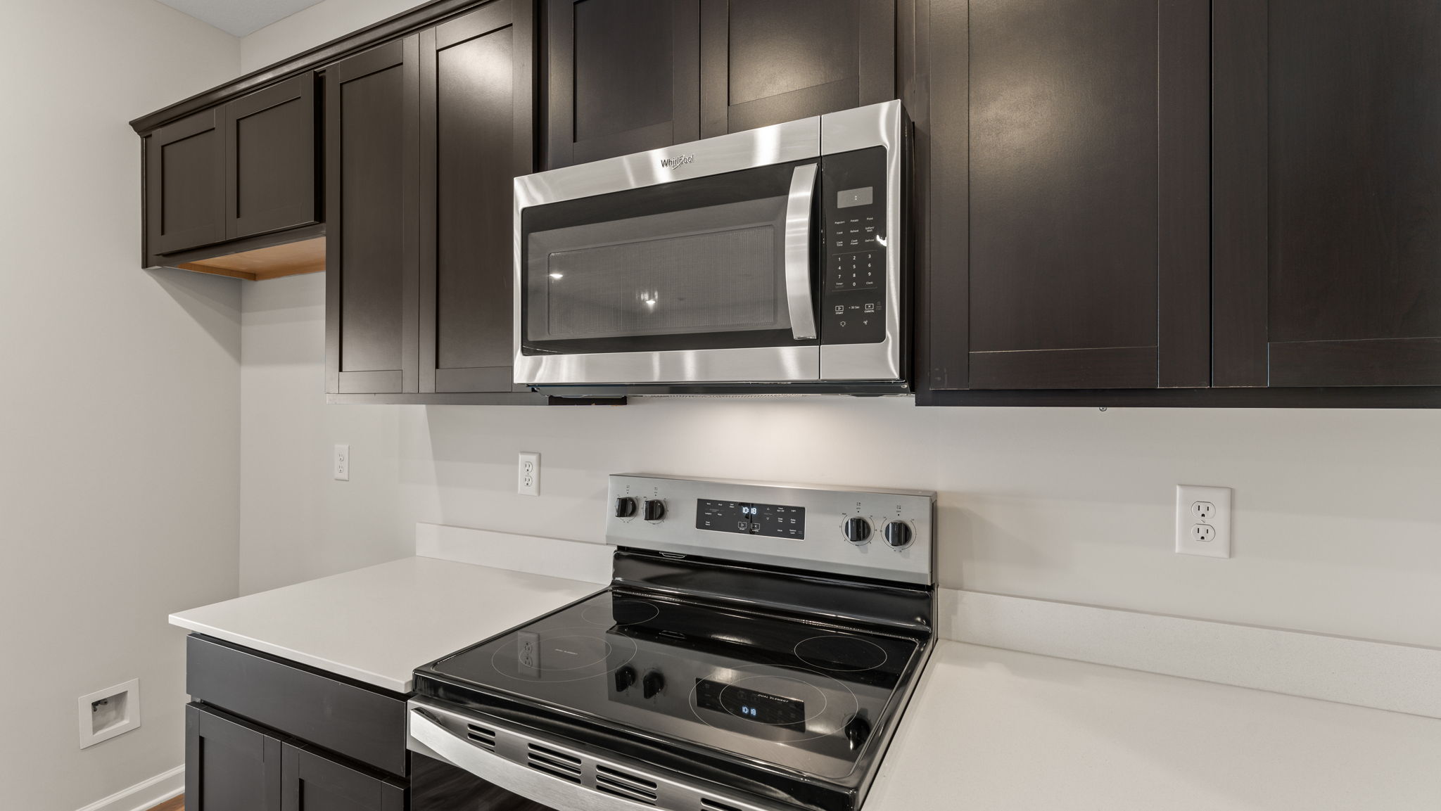 Closeup of oven range between granite countertops.