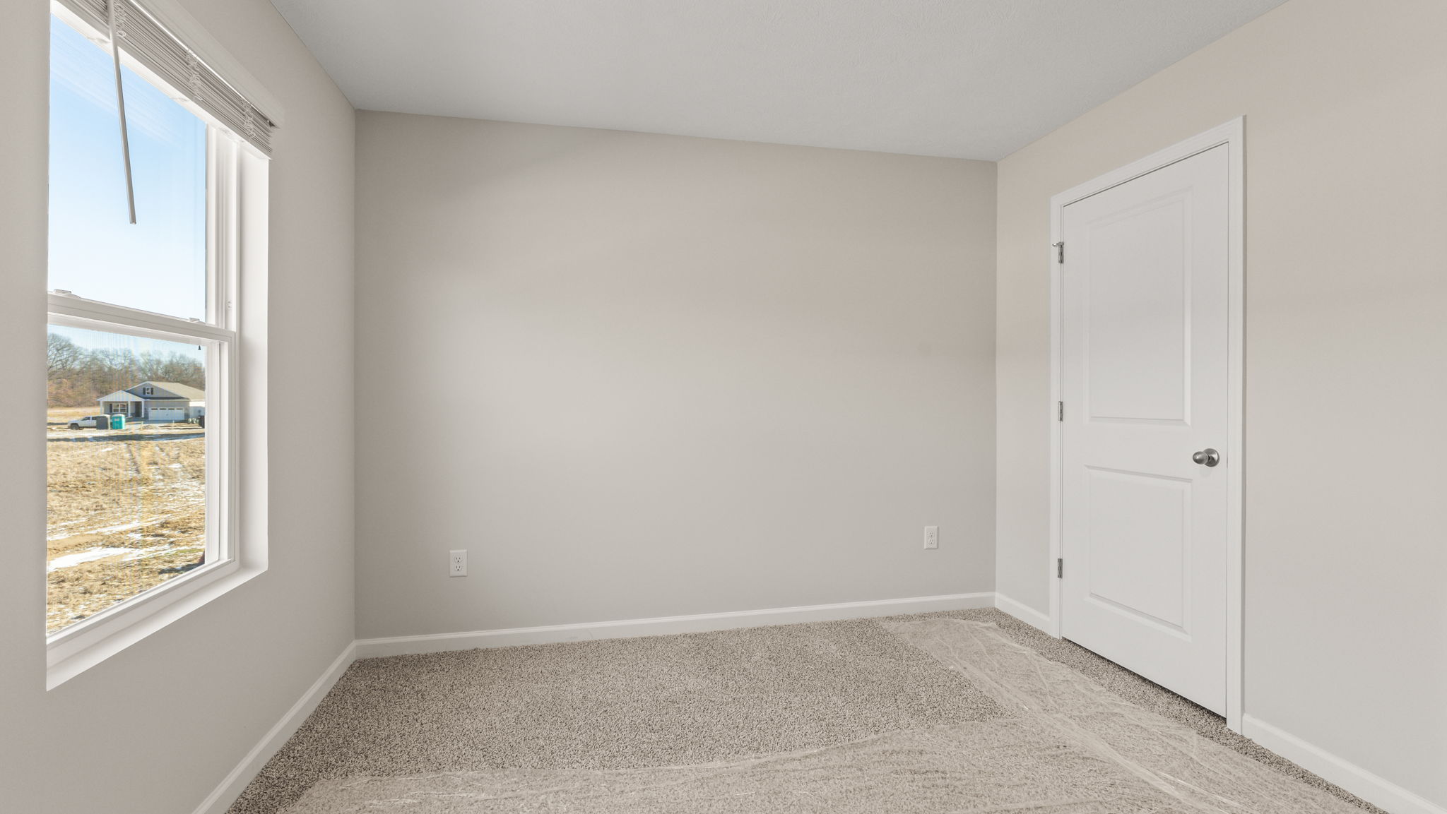 Carpeted bedroom with window