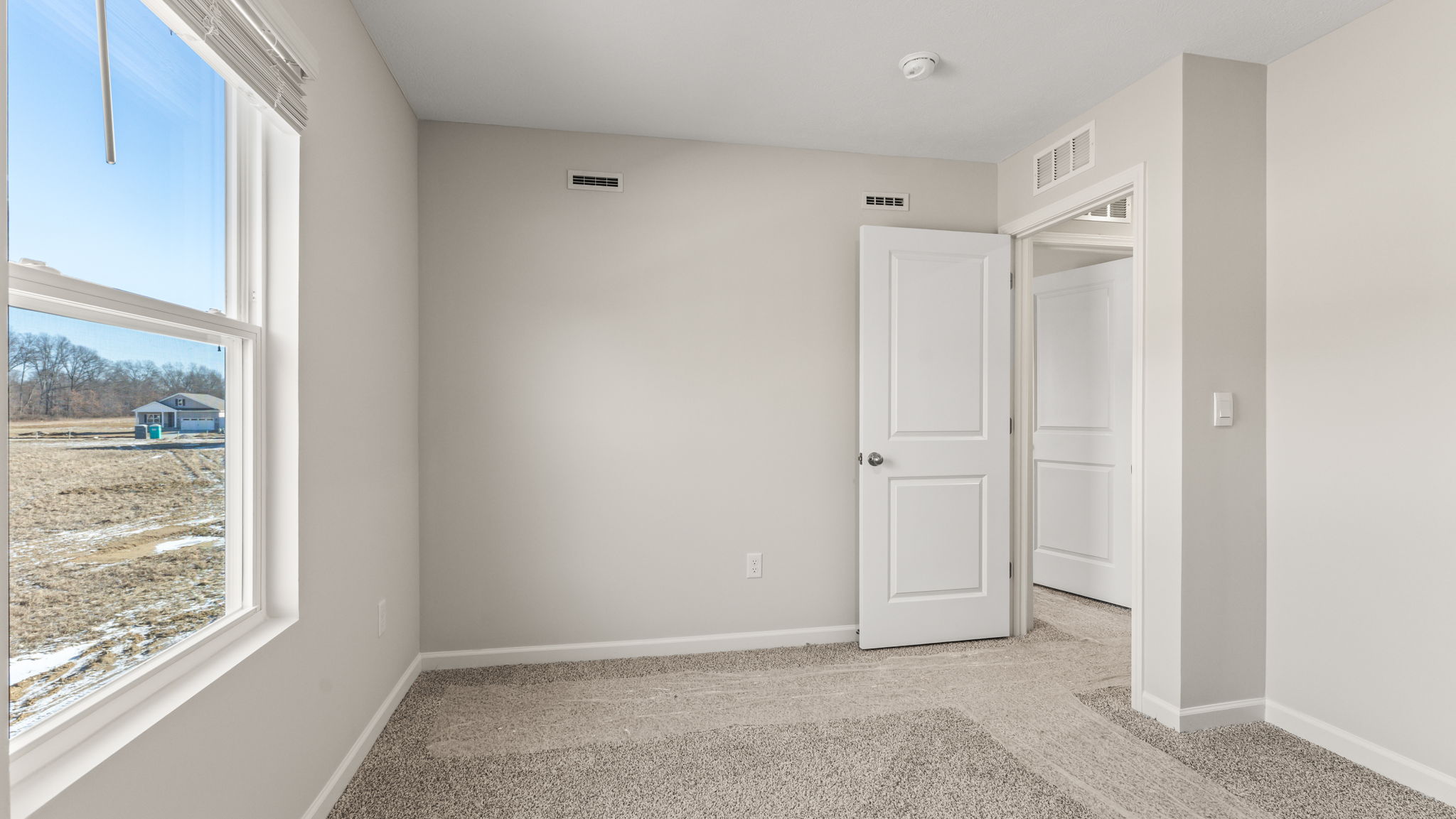 Carpeted bedroom with window