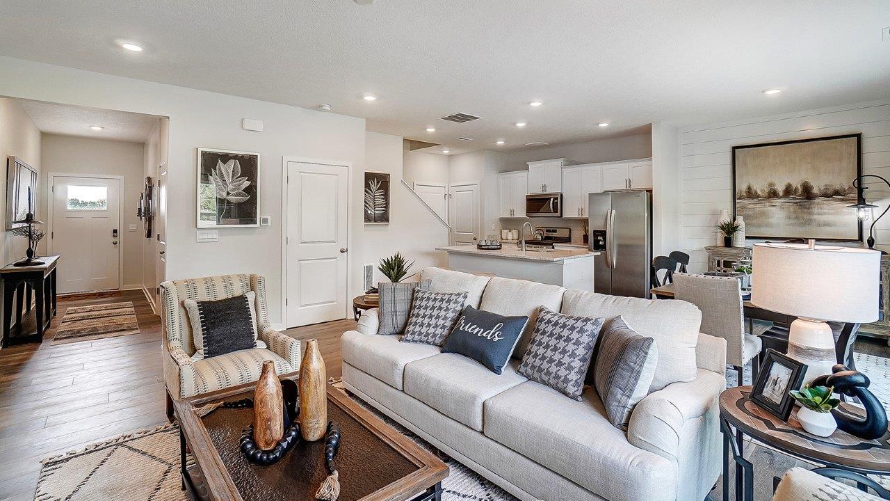 Great room in full with modern decorations and white cabinets.