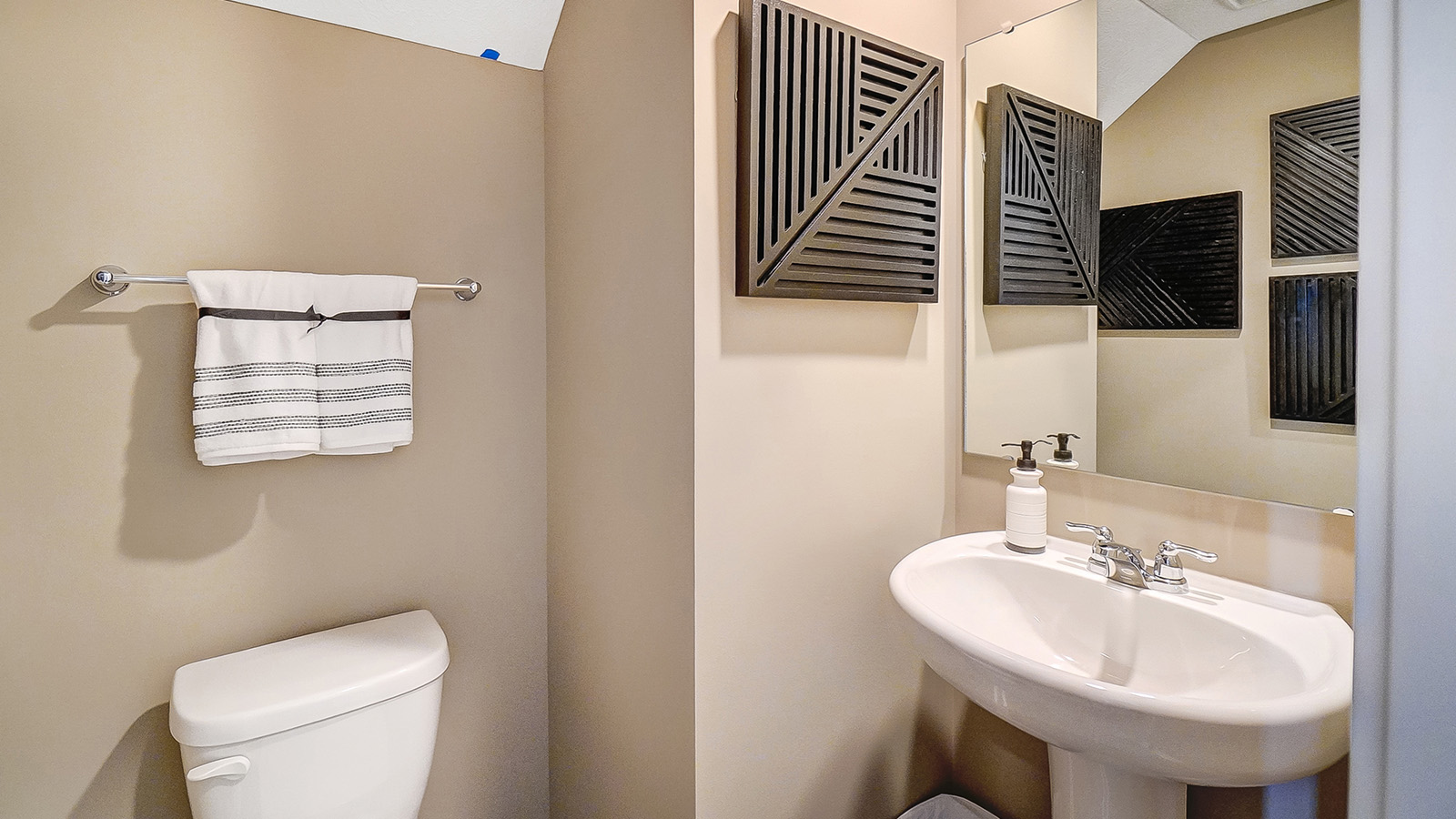 Powder room on the first floor with modern art.