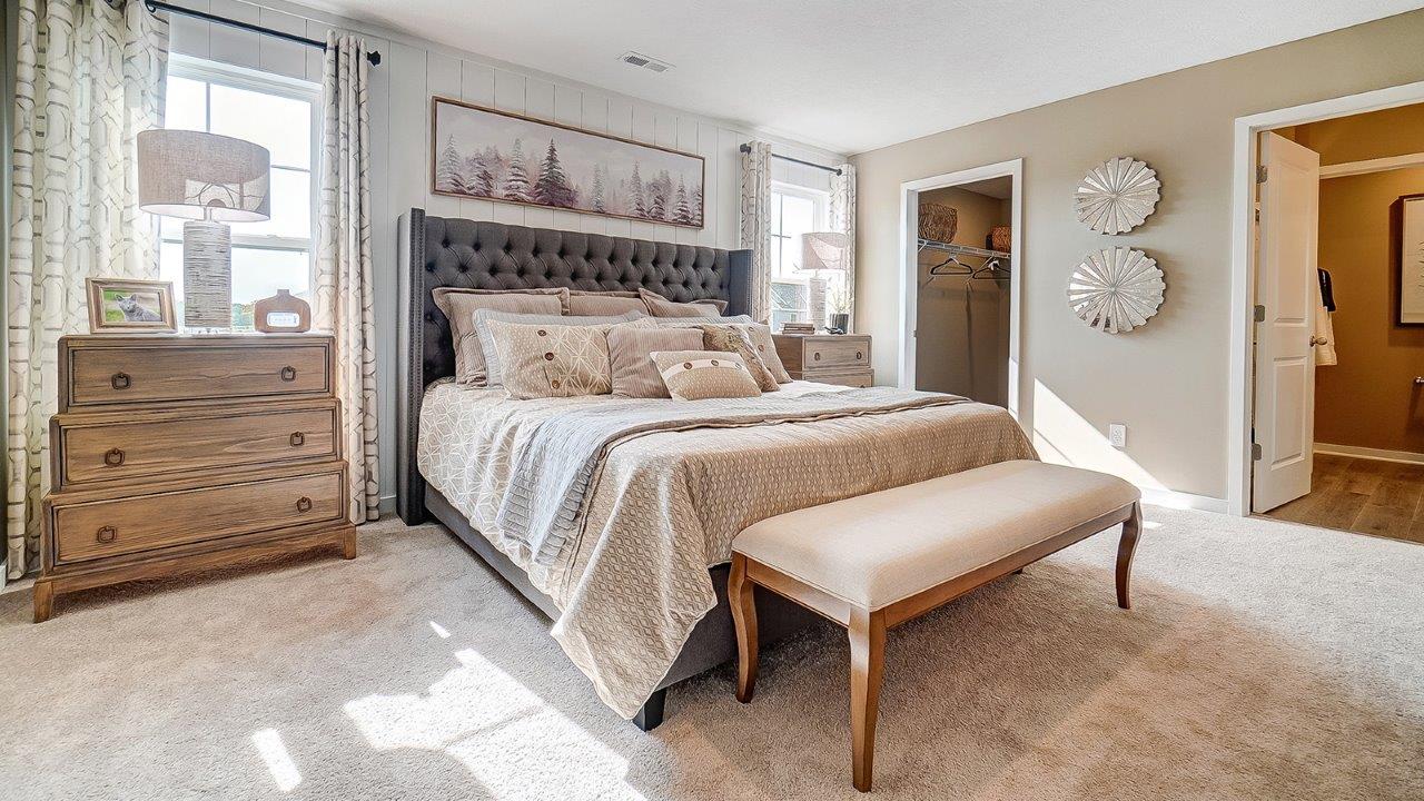 Primary bedroom with wooden décor with large king bed.