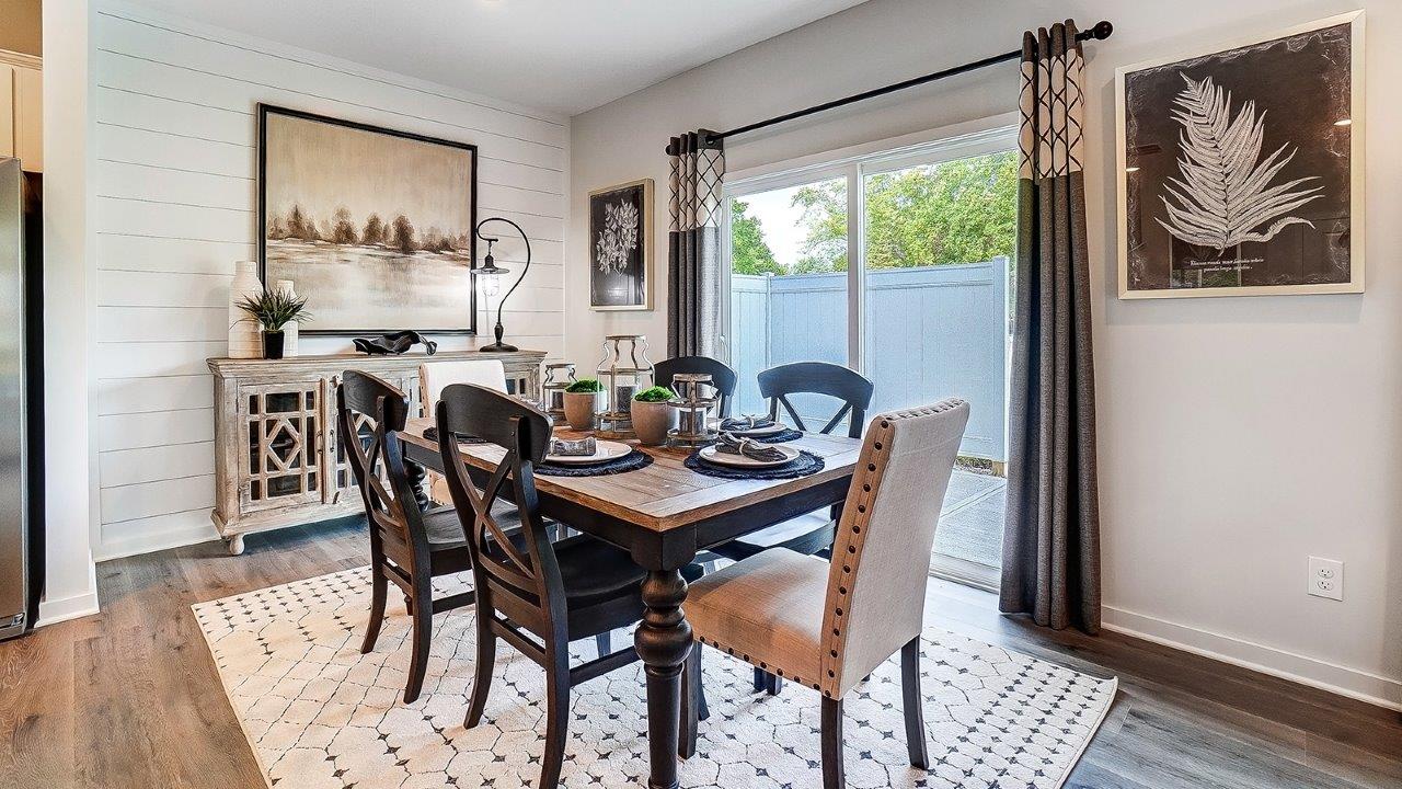 Dining area with wooden table and modern decorations.