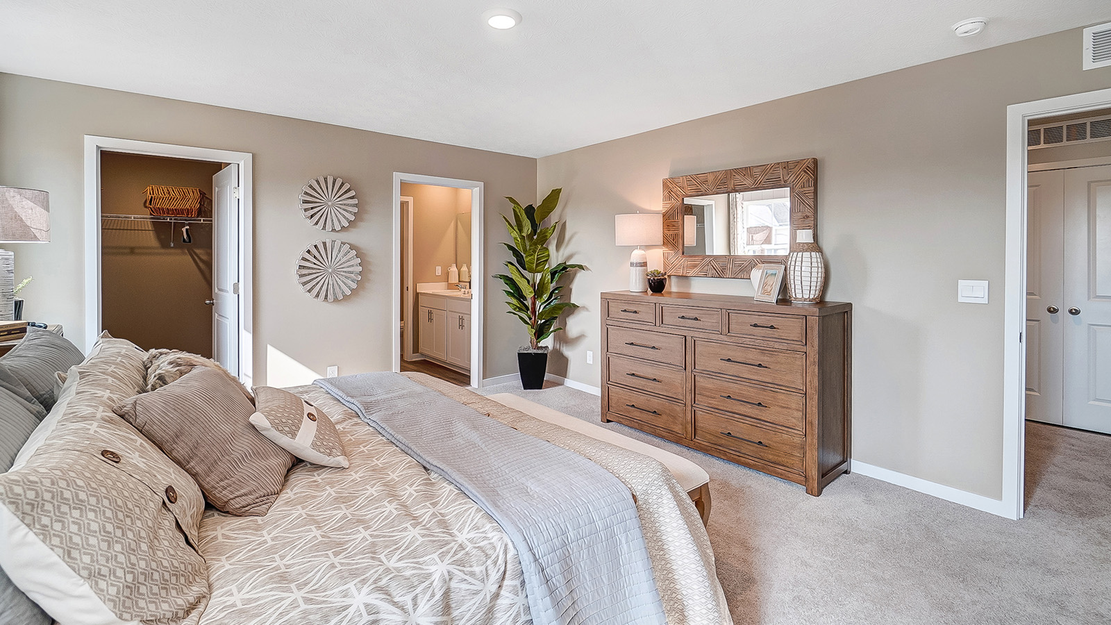 Primary bedroom with wooden décor with large king bed.