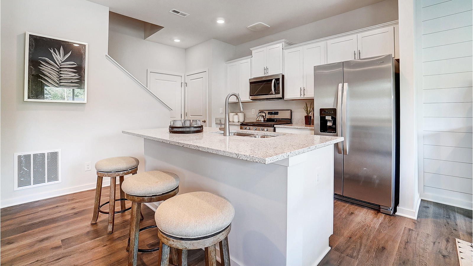 Kitchen with white cabinets and stainless steel appliances.