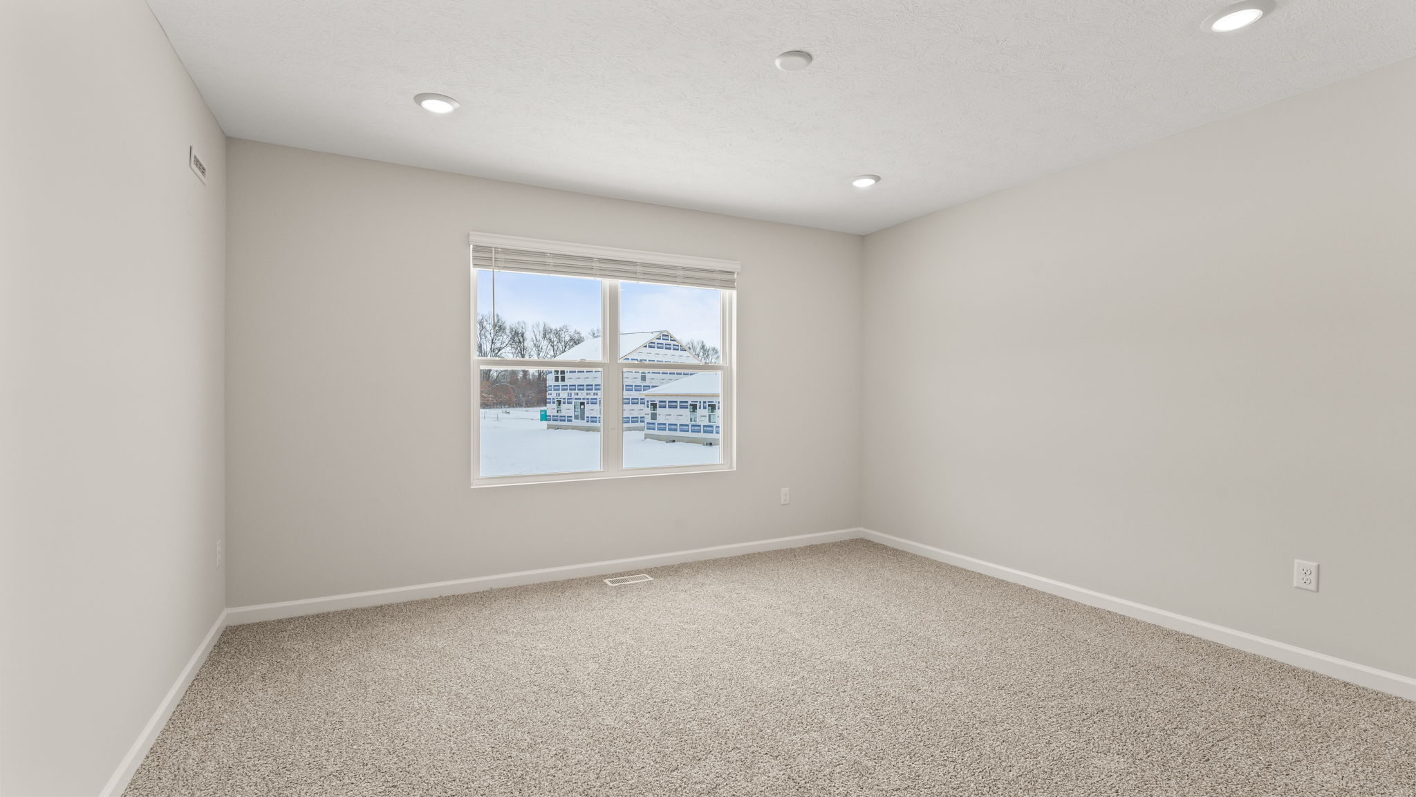 Primary bedroom with window and carpet