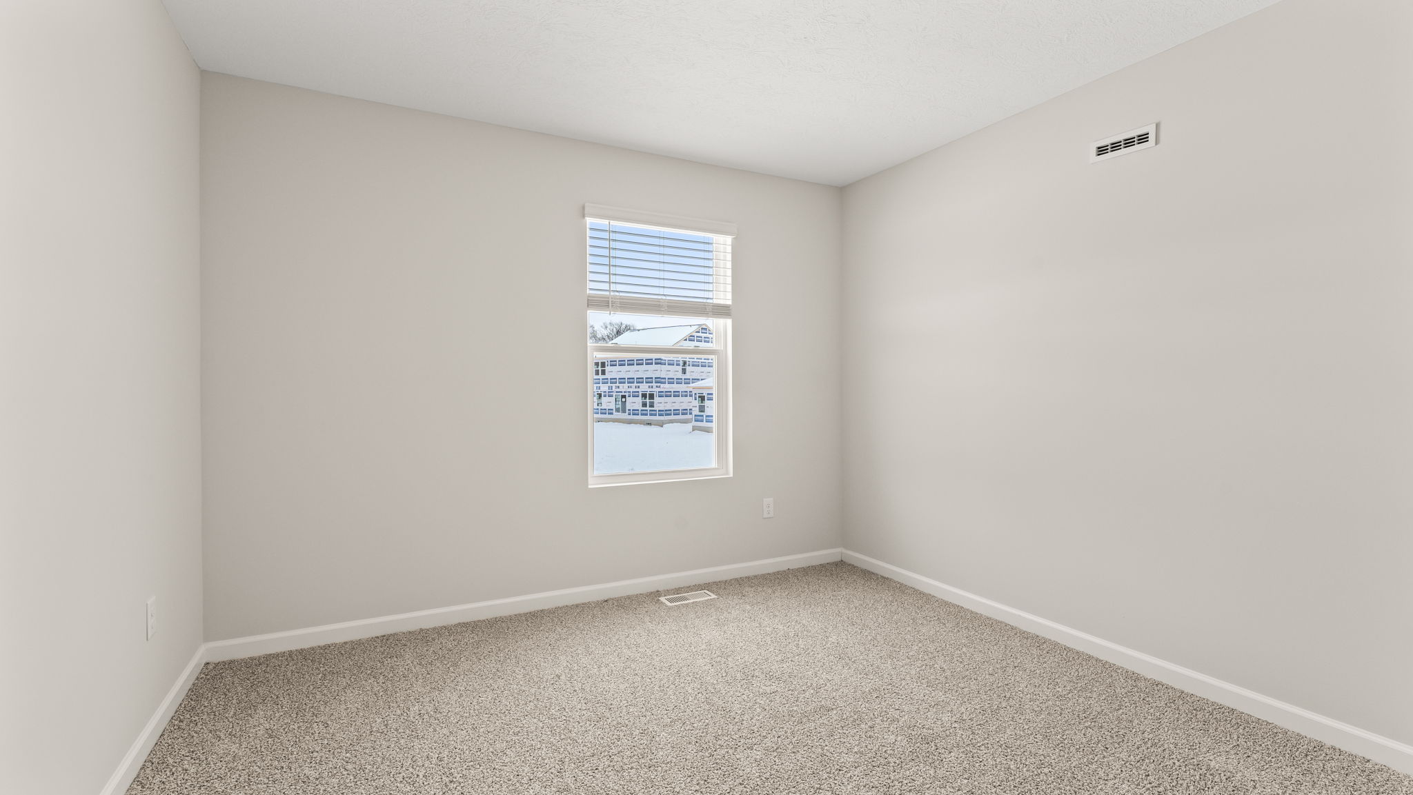 Carpeted bedroom with window