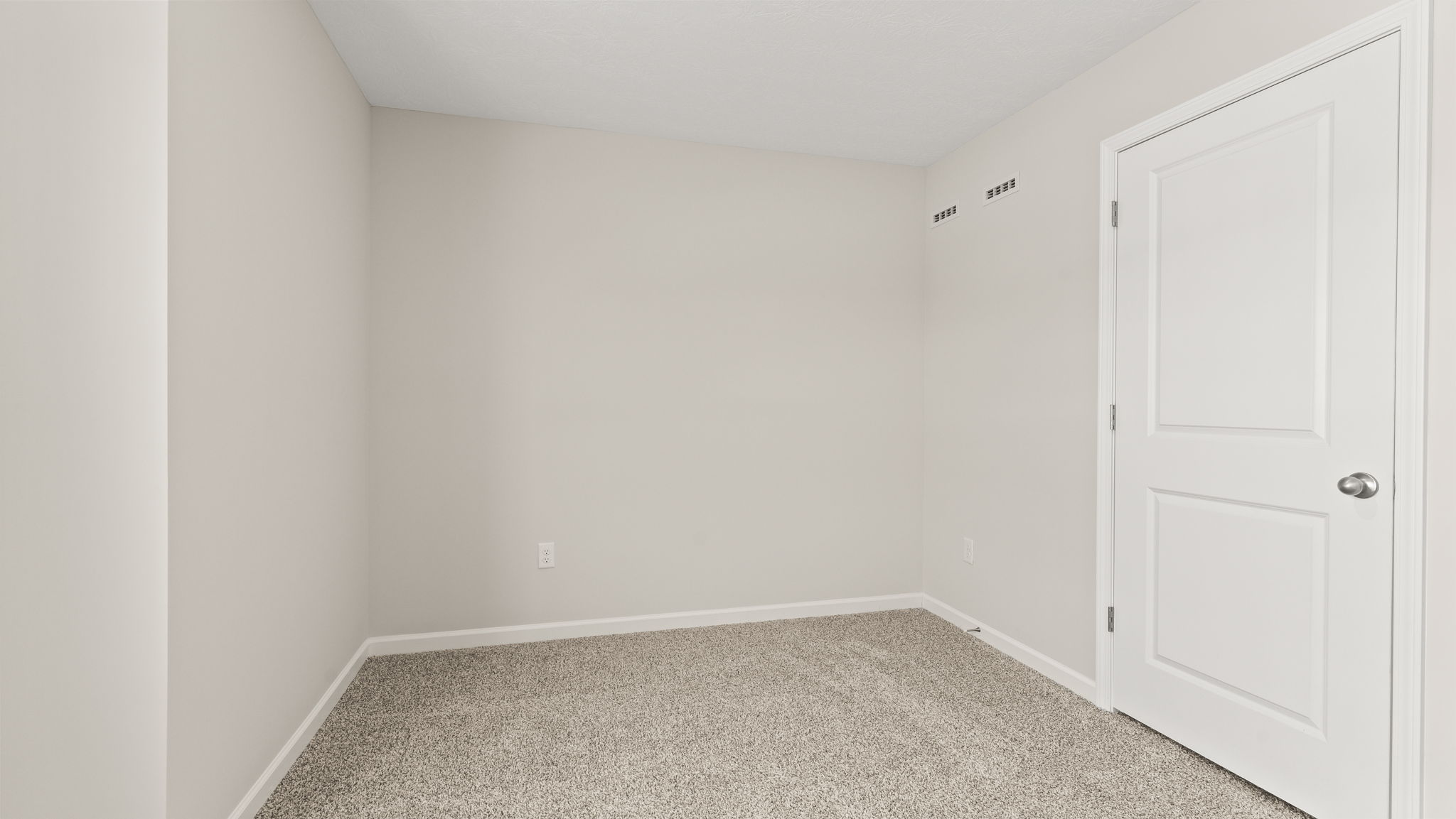 Carpeted bedroom with window