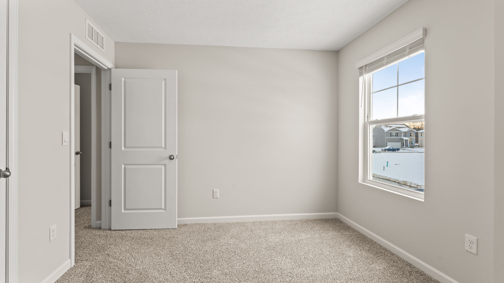 Carpeted bedroom with window