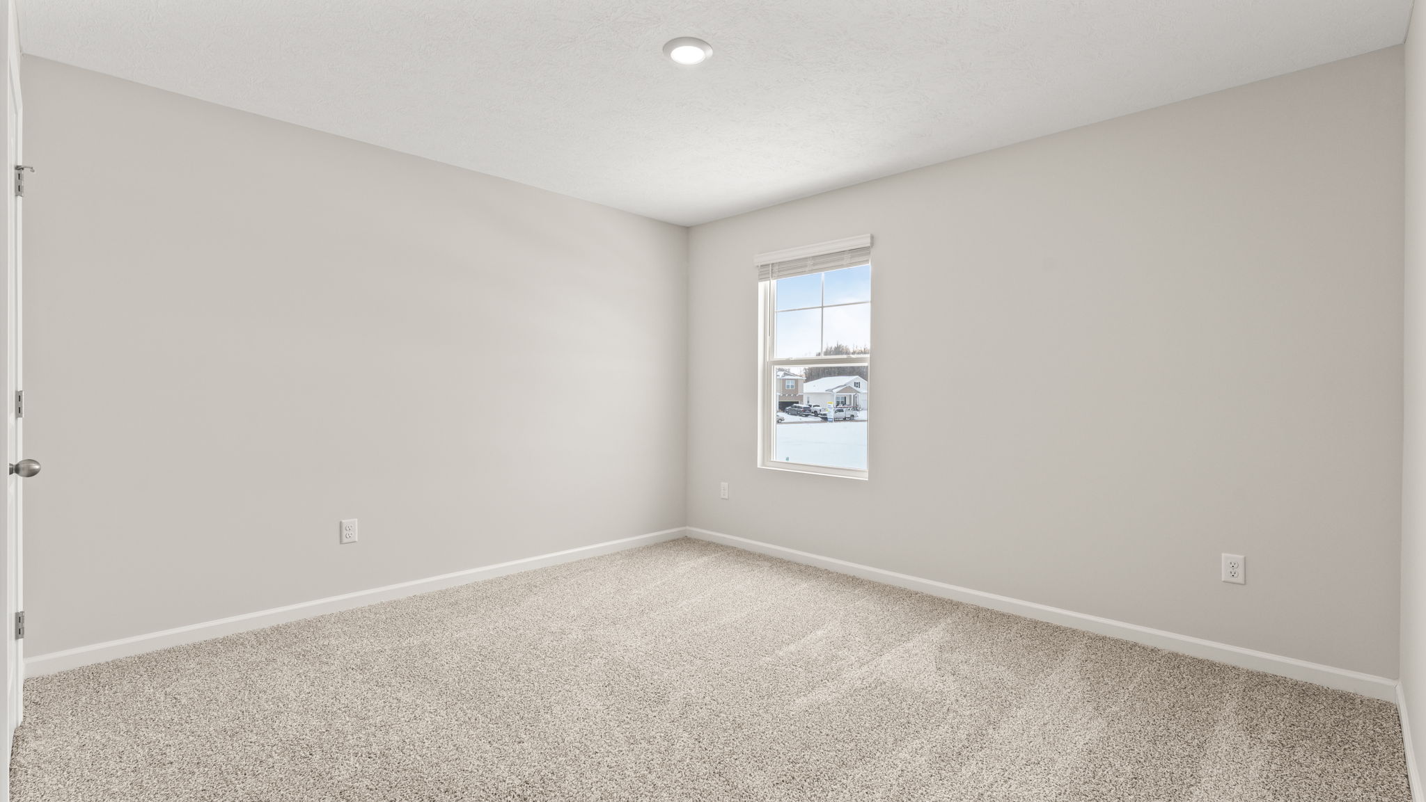 Carpeted bedroom with window