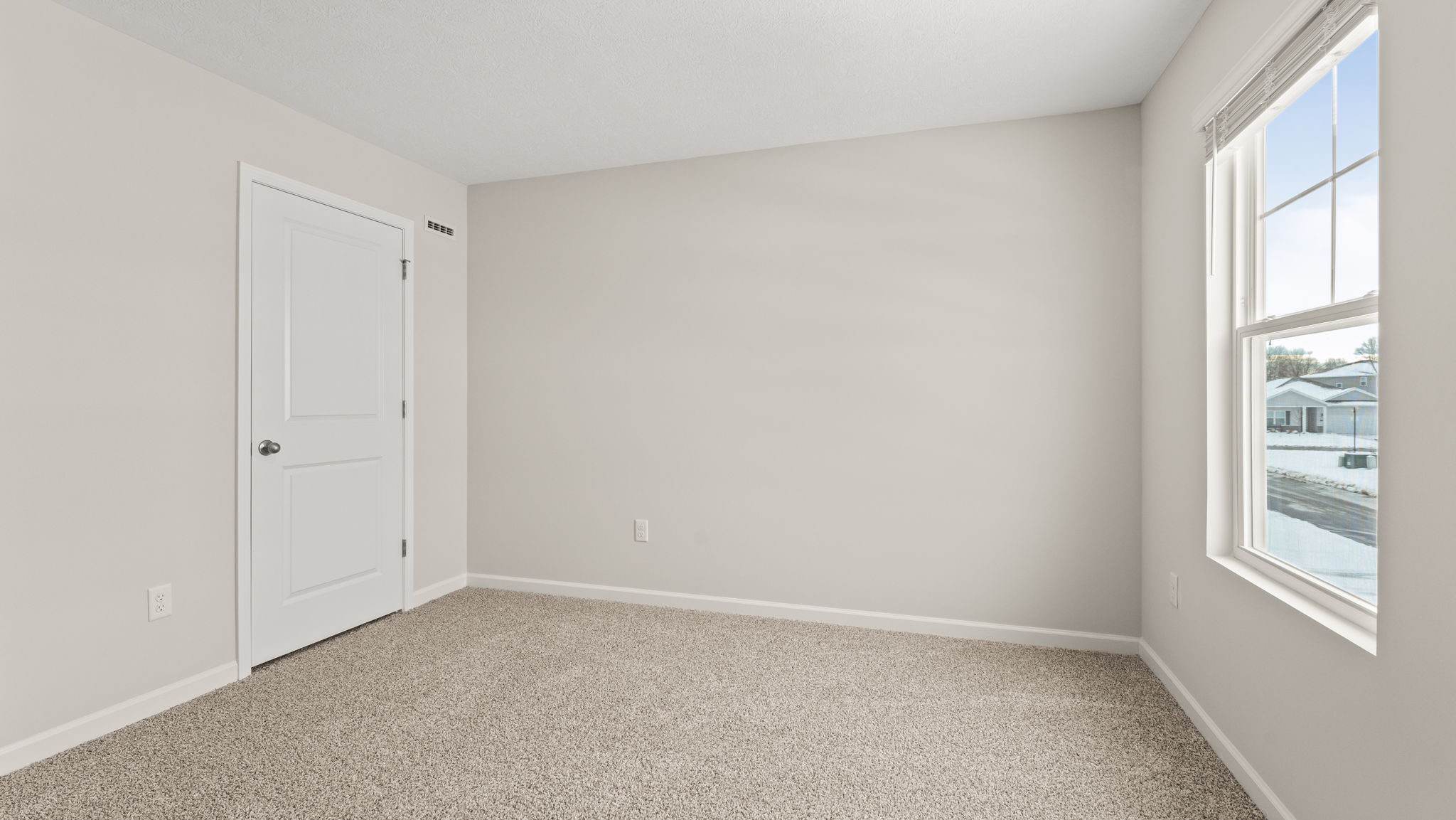 Carpeted bedroom with window