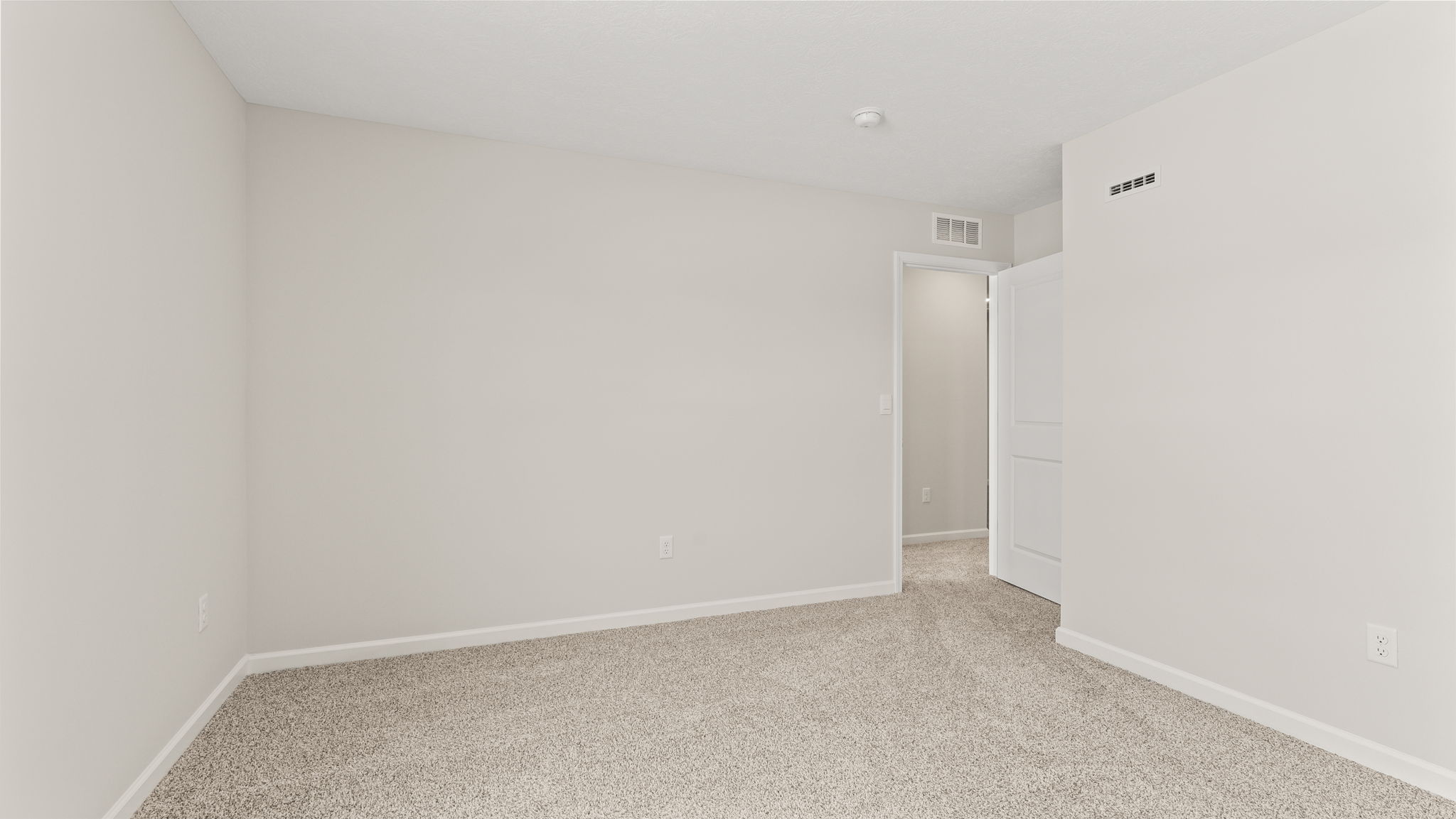 Carpeted bedroom with window