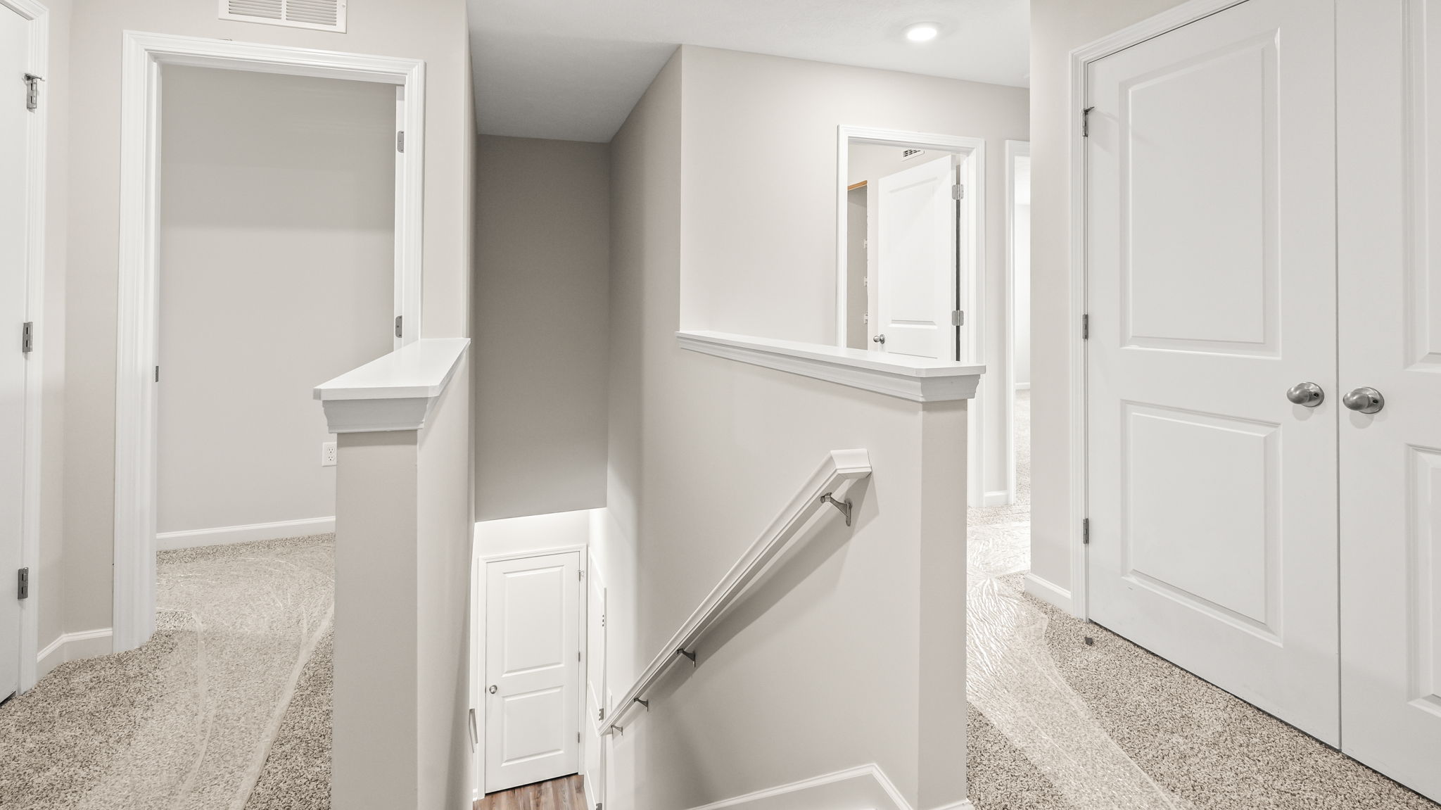 2nd level landing with doors to bedrooms and stairs downstairs
