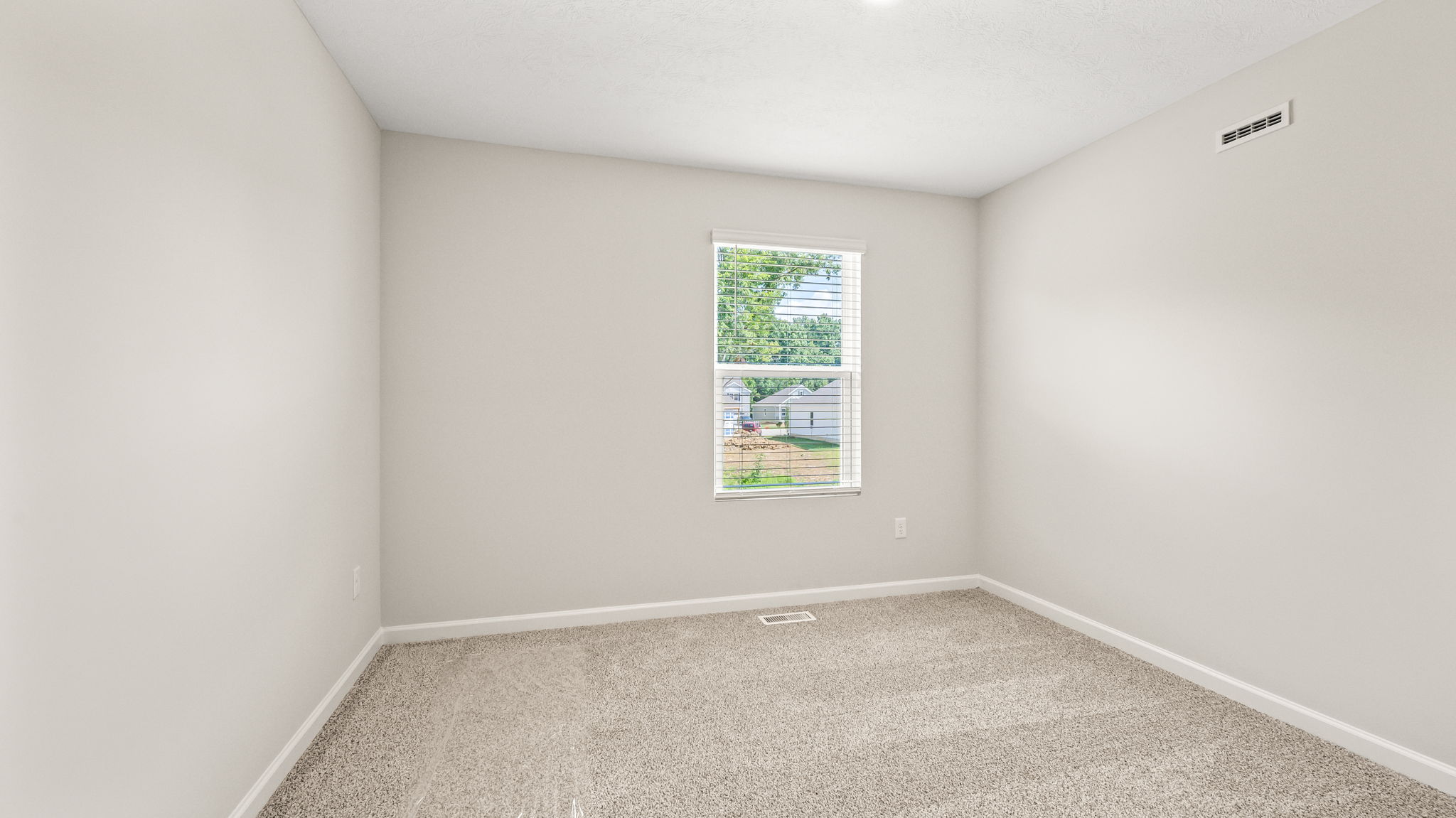 Carpeted bedroom with window