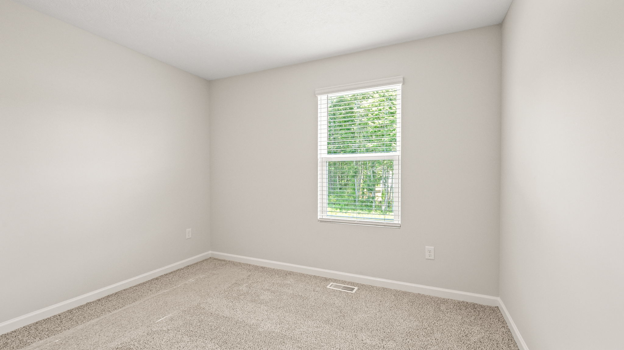 Carpeted bedroom with window