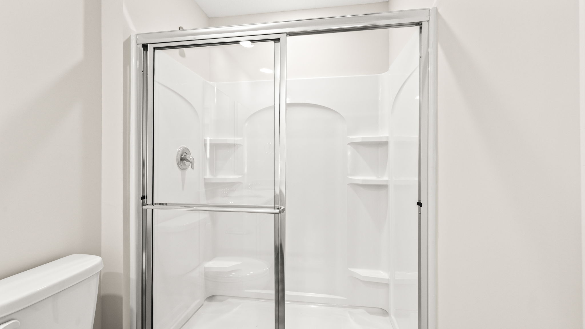 Walk-in shower with glass sliding door