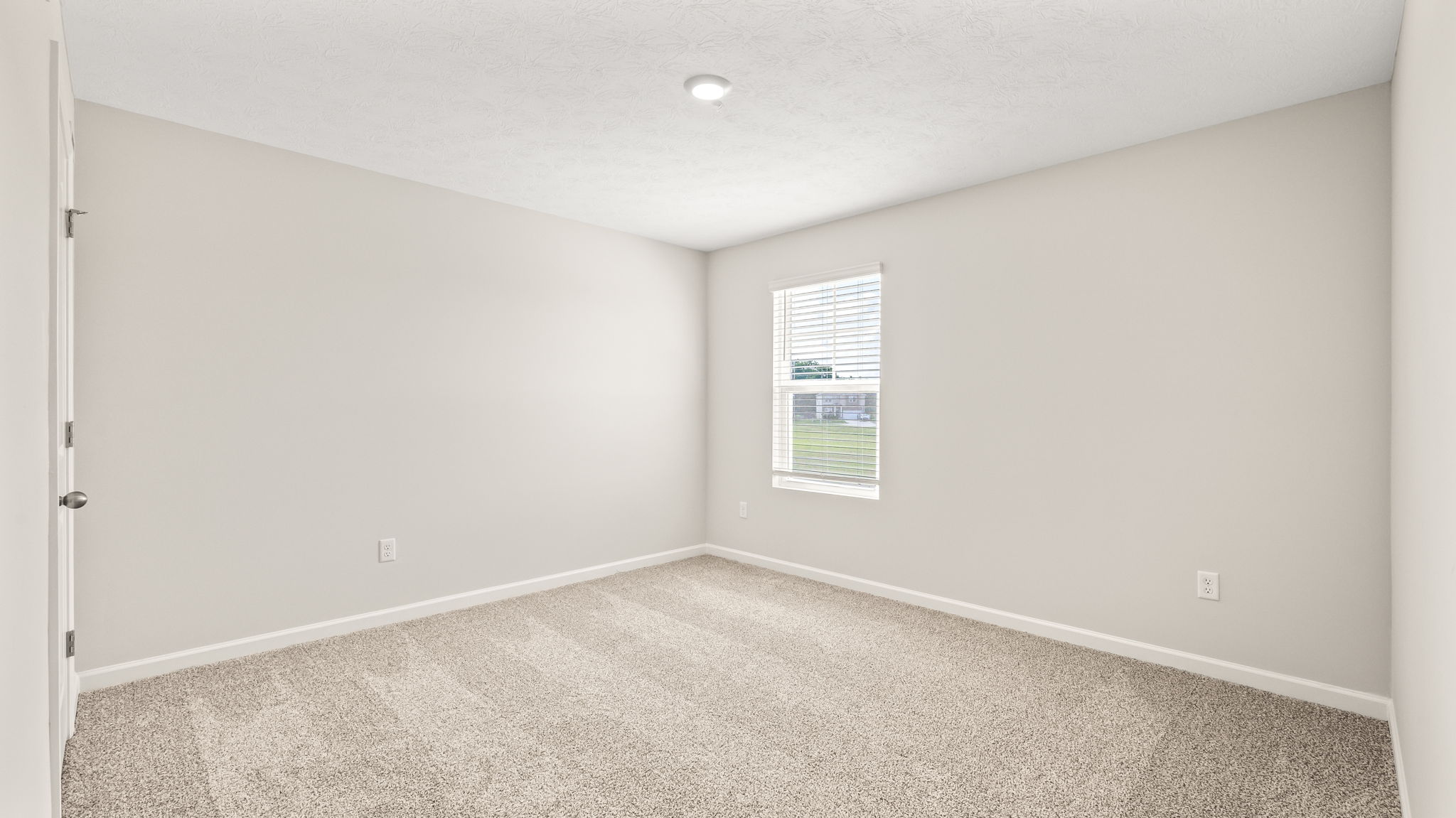 Carpeted bedroom with window