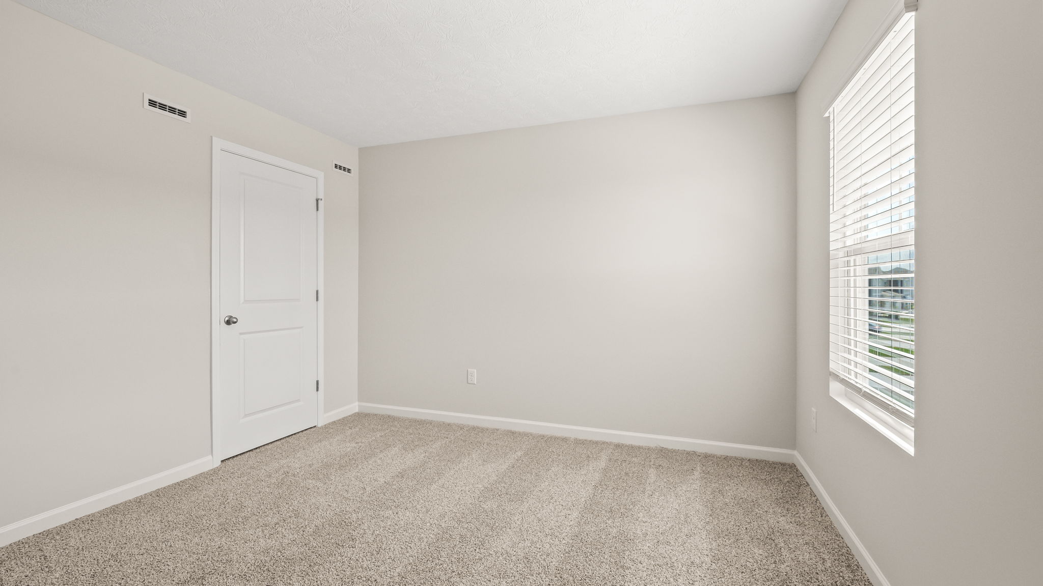 Carpeted bedroom with window