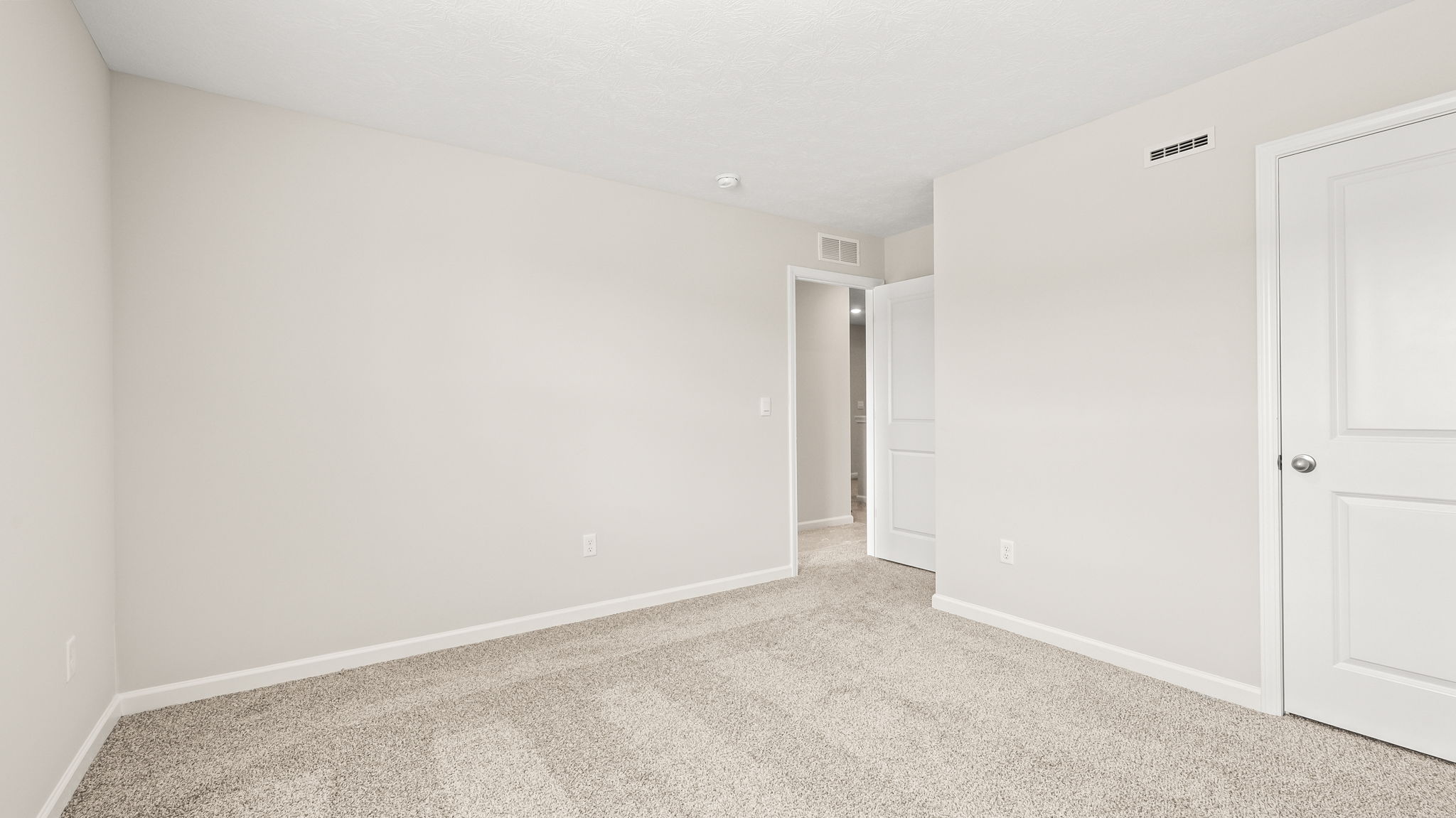 Carpeted bedroom with closet
