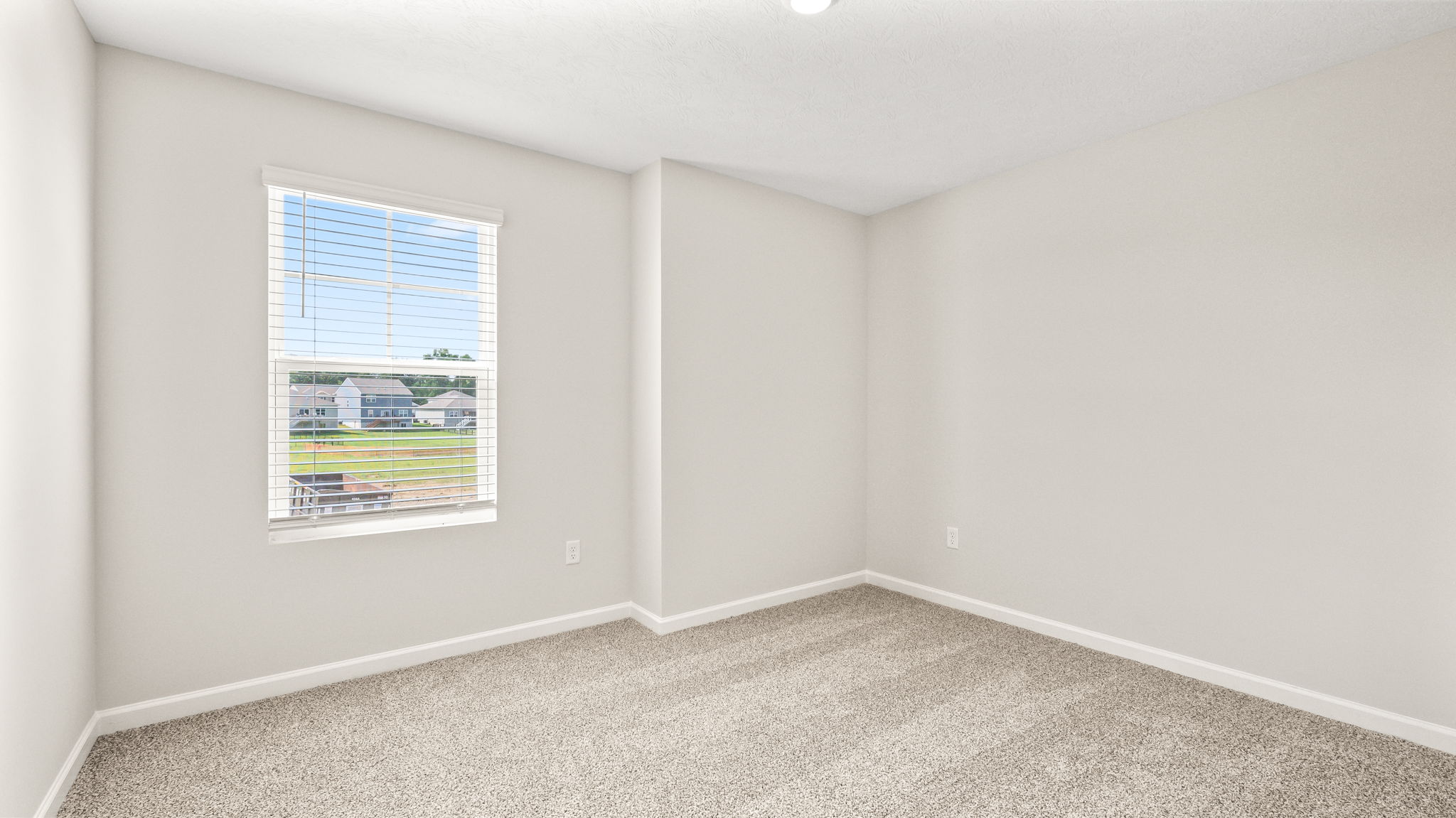 Carpeted bedroom with window