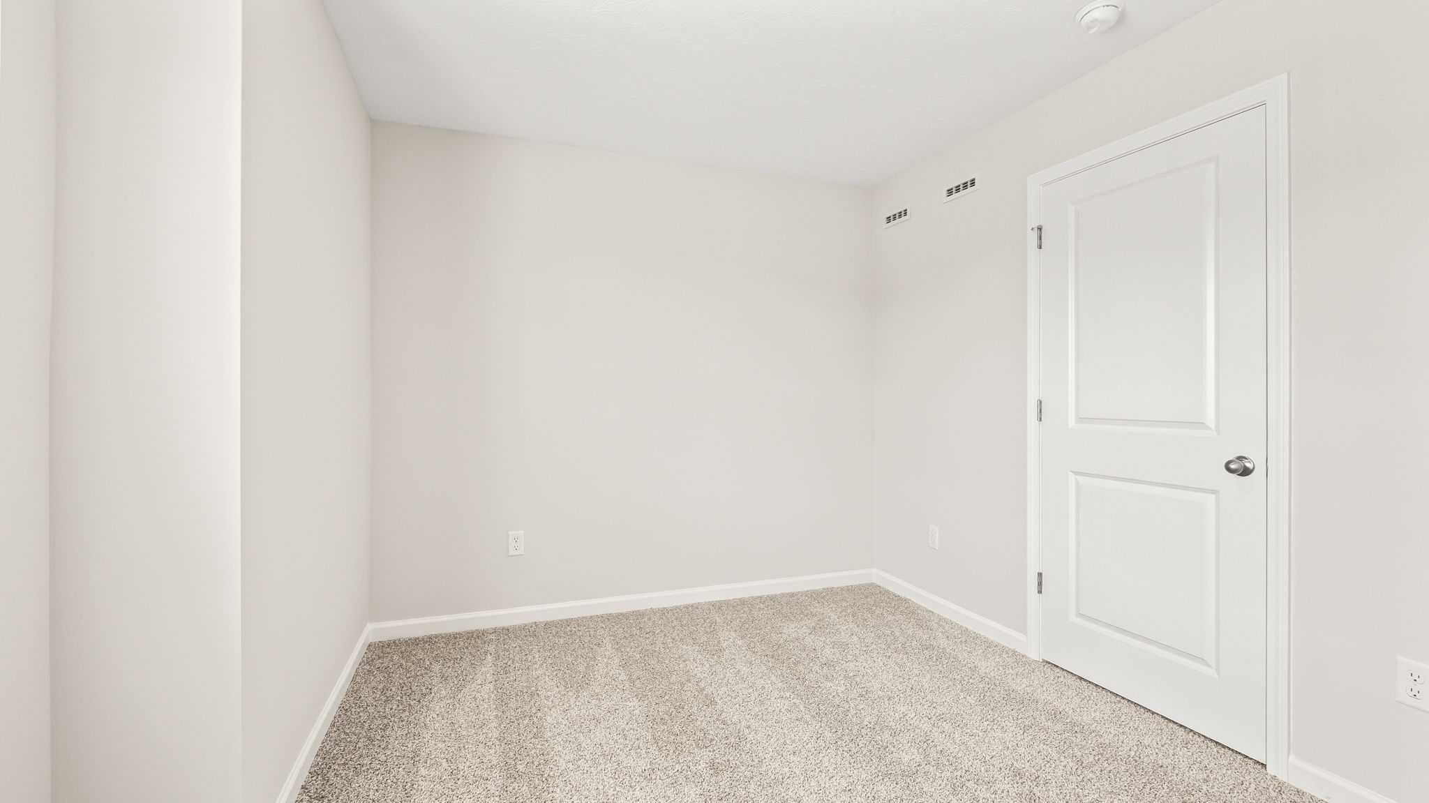 Carpeted bedroom with closet
